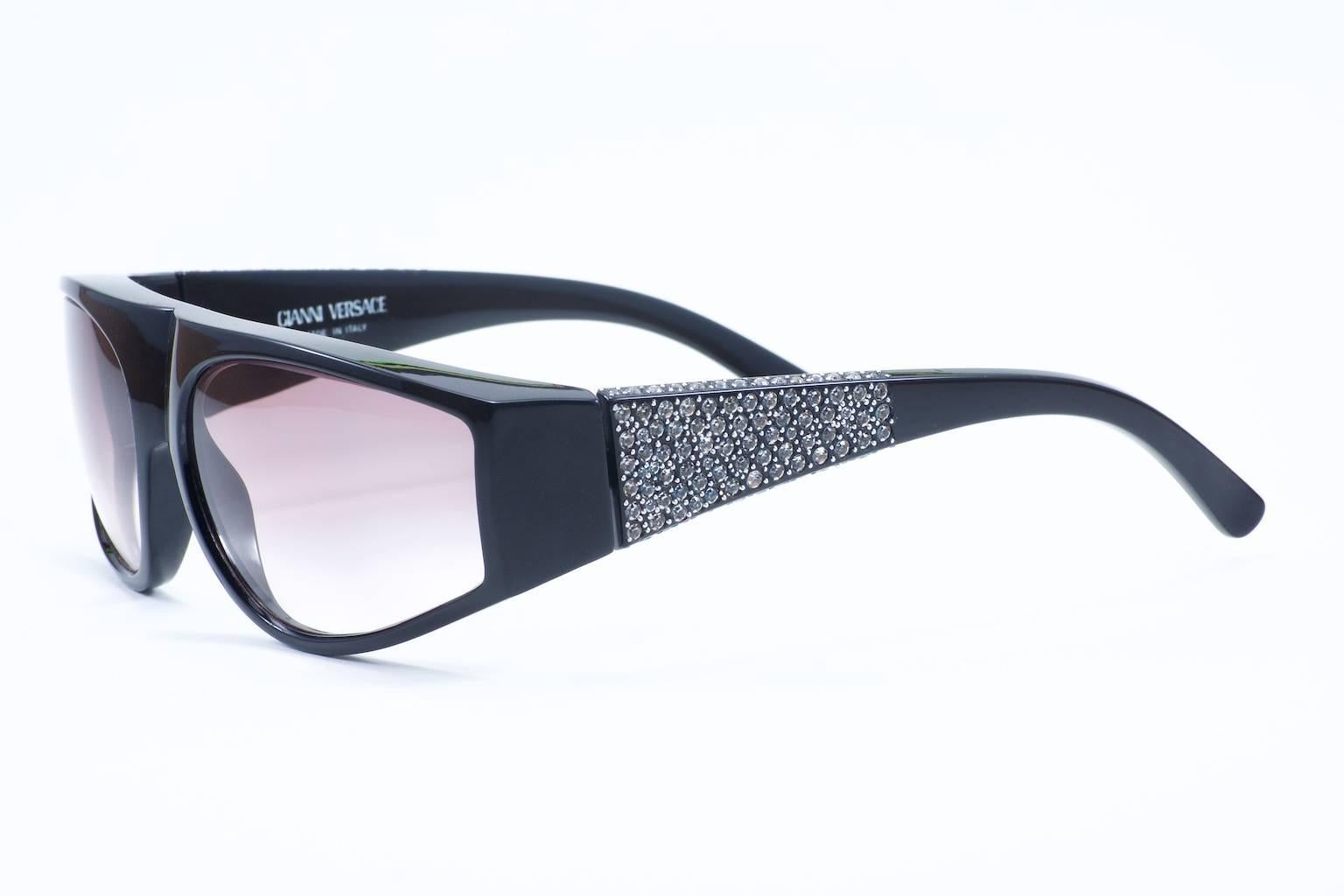 Vintage Versace Basix sunglasses c early 1990s feature a stunning array of rhinestones, not just on the side but also continuing onto the top of the ear stem, and this was the very first style in which Gianni Versace incorporated rhinestones into