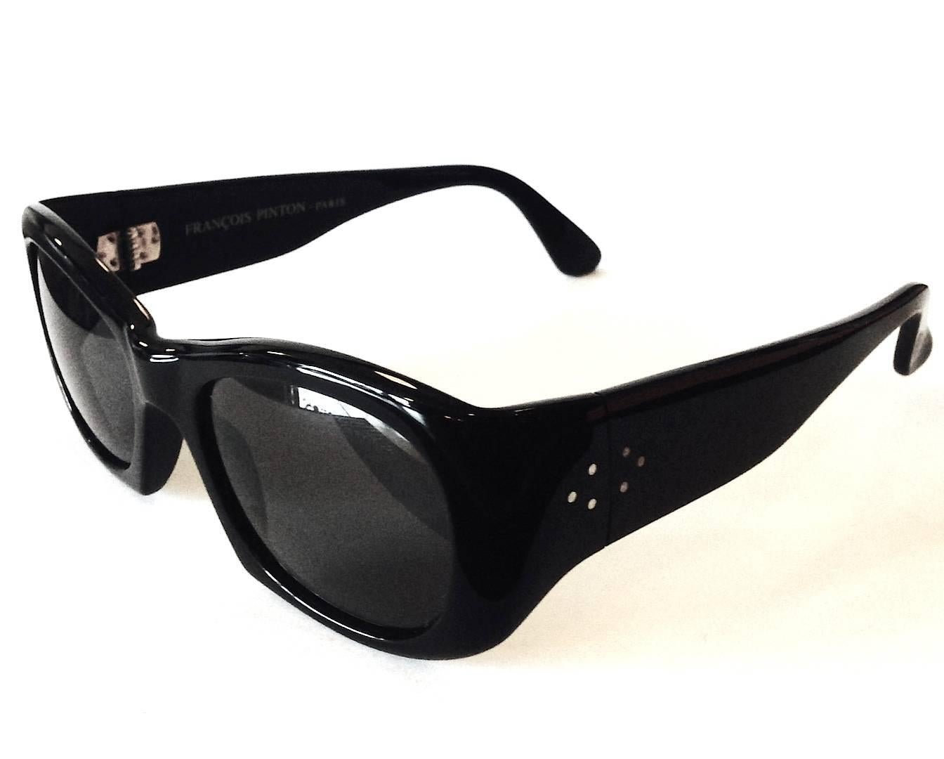 Designed and manufactured by Francois Pinton in the mid 1960s and still made today from original blueprint by same original designer.
Smooth-lined, bold body, wide temples. Frame color Noir. 
Lens Size  - 50mm 
Bridge Width - 20mm  
Temple