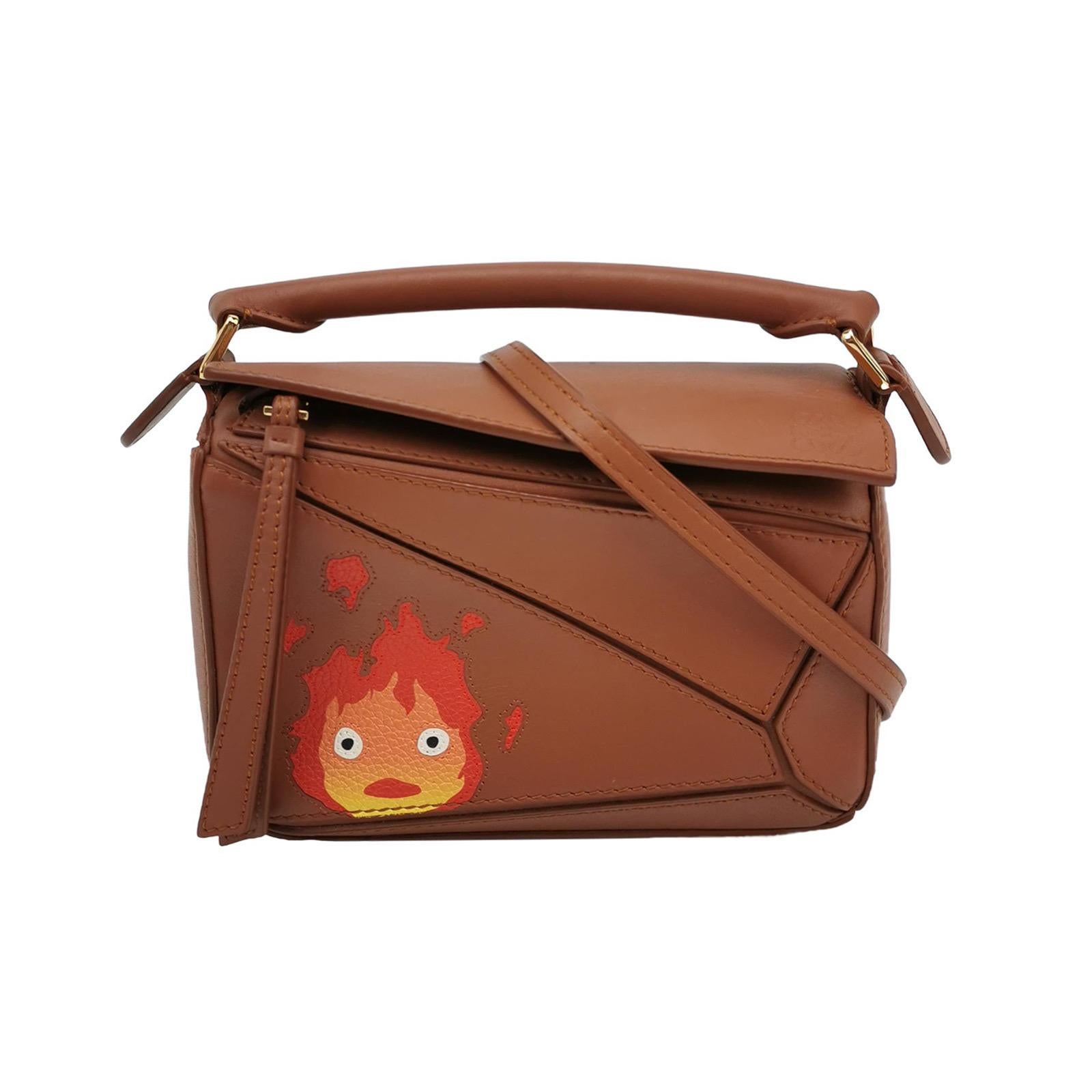 Loewe x Howl's Moving Castle Studio Ghibli Collection Puzzle Calcifer Mini Tan Brown
These are professional photos of the actual bag offered by Luxbags.

This is from the sell-out collaboration between Loewe and the Japanese anime studio Studio