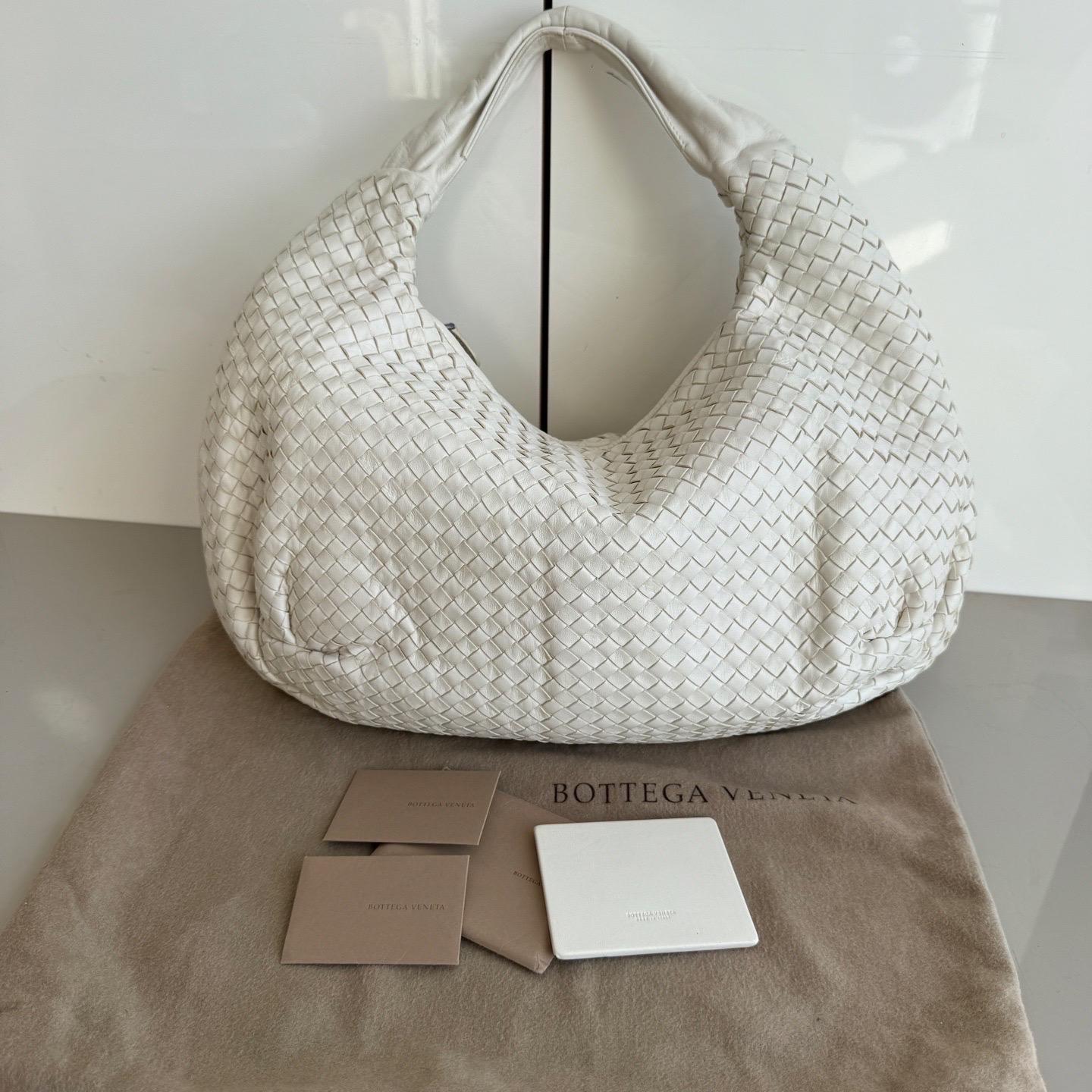Prova il lusso assoluto con questa borsa Hobo di Bottega Veneta in pelle d'agnello. Caratterizzata dall'iconica trama Intrecciato, questa borsa offre ampio spazio per tutti i tuoi oggetti essenziali. Perfetto per elevare il tuo stile invernale con