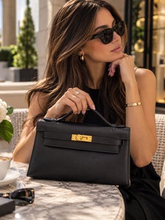 Pochette Hermès Kelly en cuir Swift noir avec finitions dorées