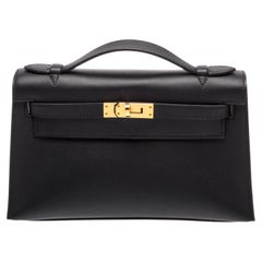 Pochette Hermès Kelly en cuir Swift noir avec finitions dorées