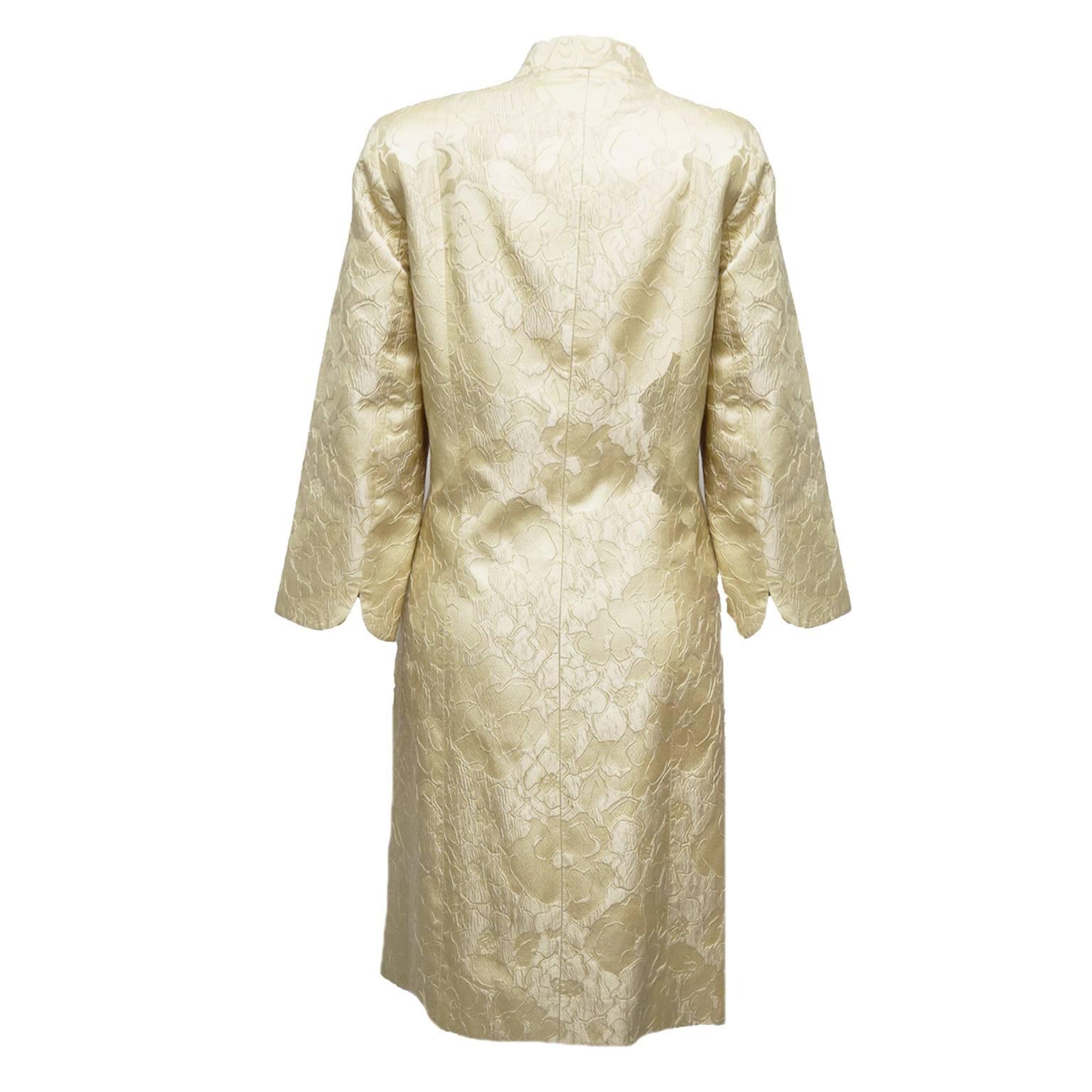 This exquisite piece is the epitome of elegance. Made with brocade and lined with light gold silk, wearing this piece is a luxury. Mandarin Collar, side slits, and 3 quarter length sleeves. Darts included to add slimming features and to compliment