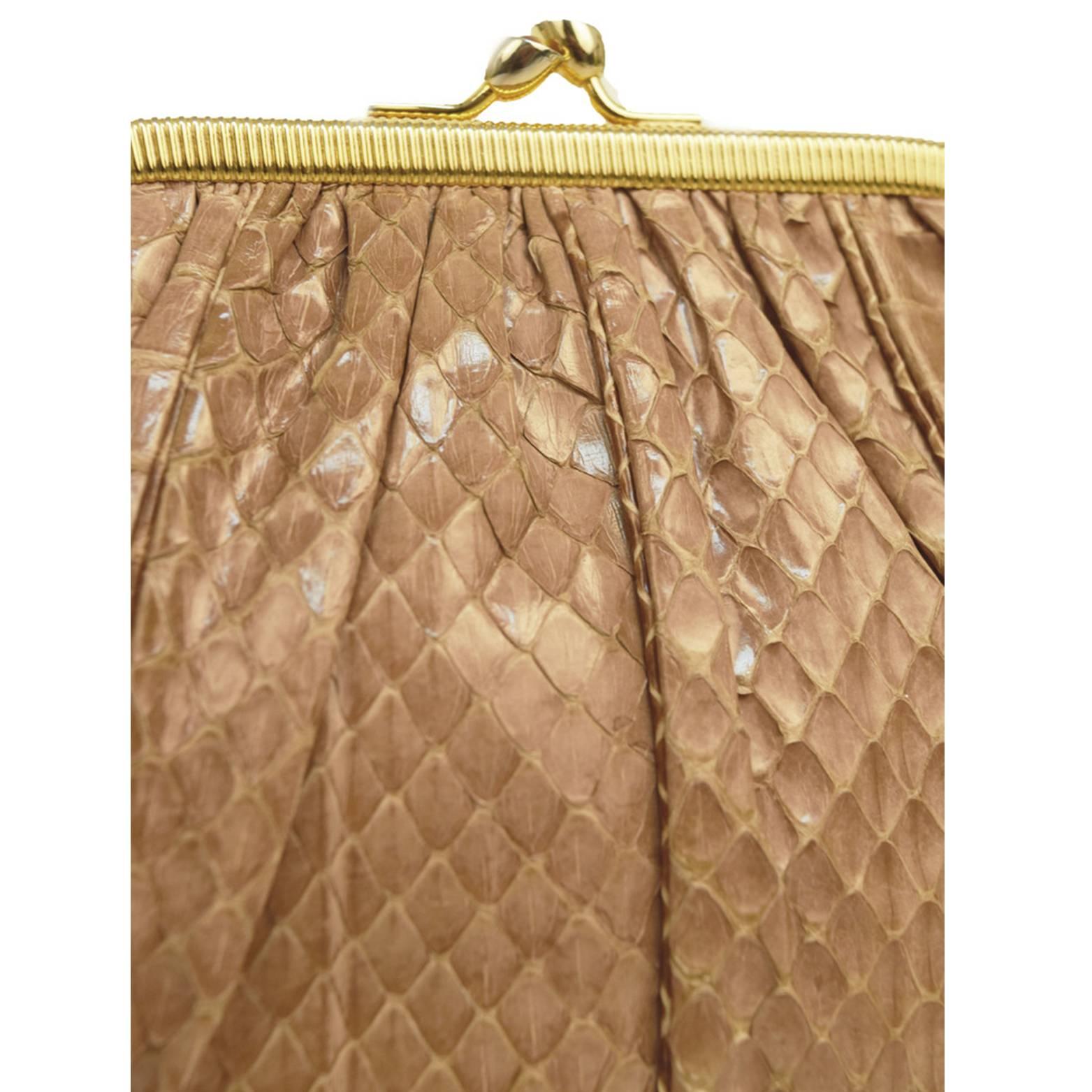 This Judith Leiber vintage convertible clutch is made from real blush snakeskin. Has gold dutch closure and tiger's eye precious gem embellishment.