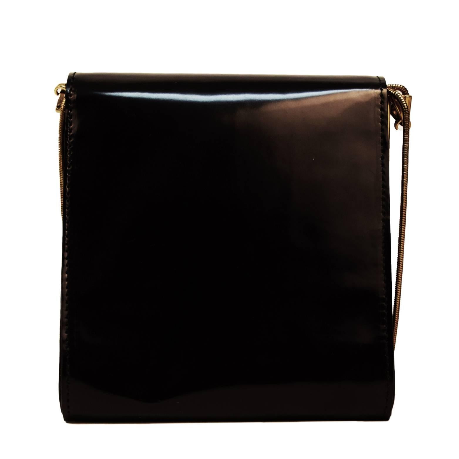 This Vionnet shoulder bag is black patent leather with a gold metal and leather blend bow embellishment. Snap closure and double flapped with two separate compartments. Shoulder strap is made from gold chain links and is very lightweight. $1200 SOLD