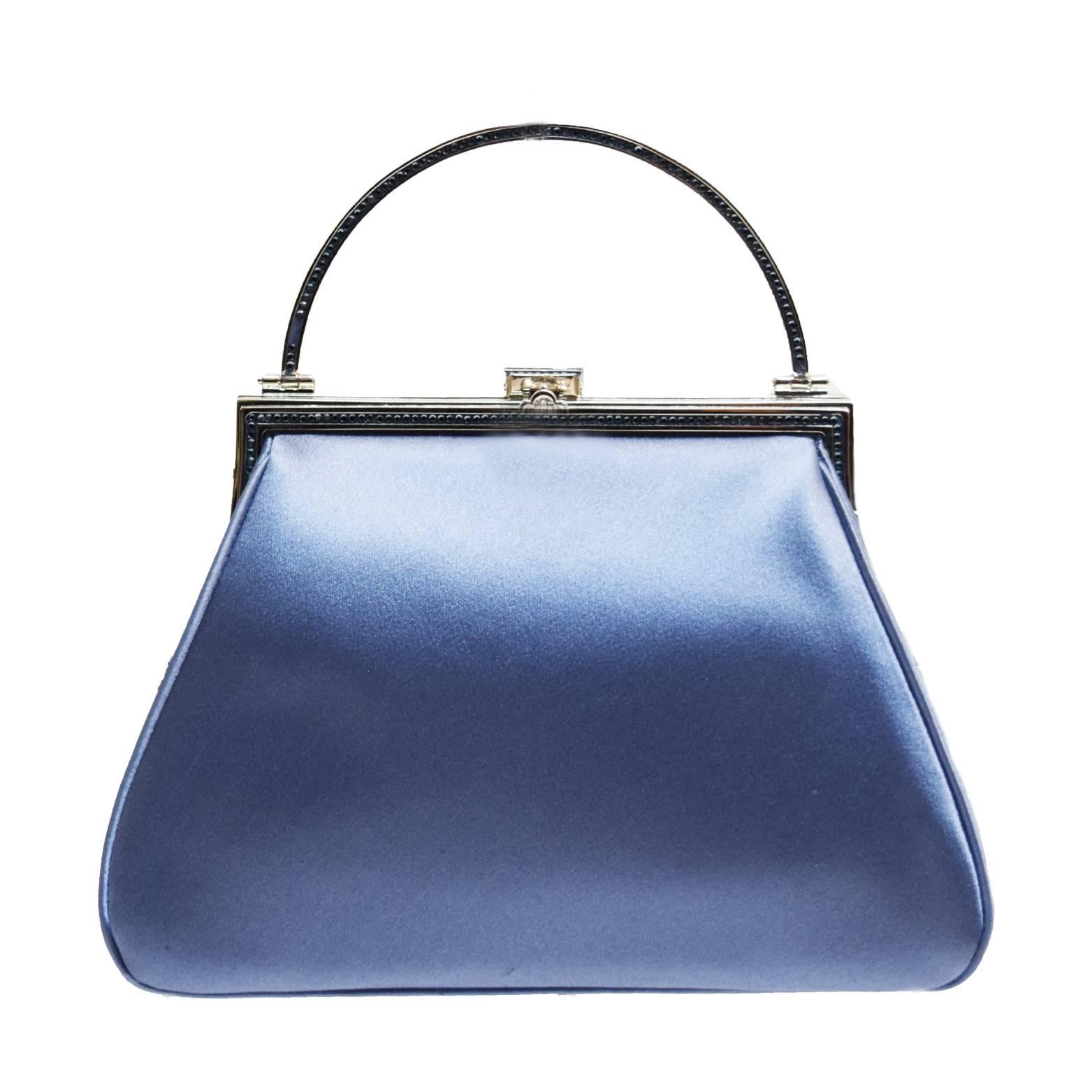 Judith Leiber Hydrangea blue silk satin evening bag. Silver metal frame, chain shoulder strap and small handle embellished with blue Swarovski crystals on both sides of the frame and handle. Clasp is a silver handbag embellished with clear Swarovski