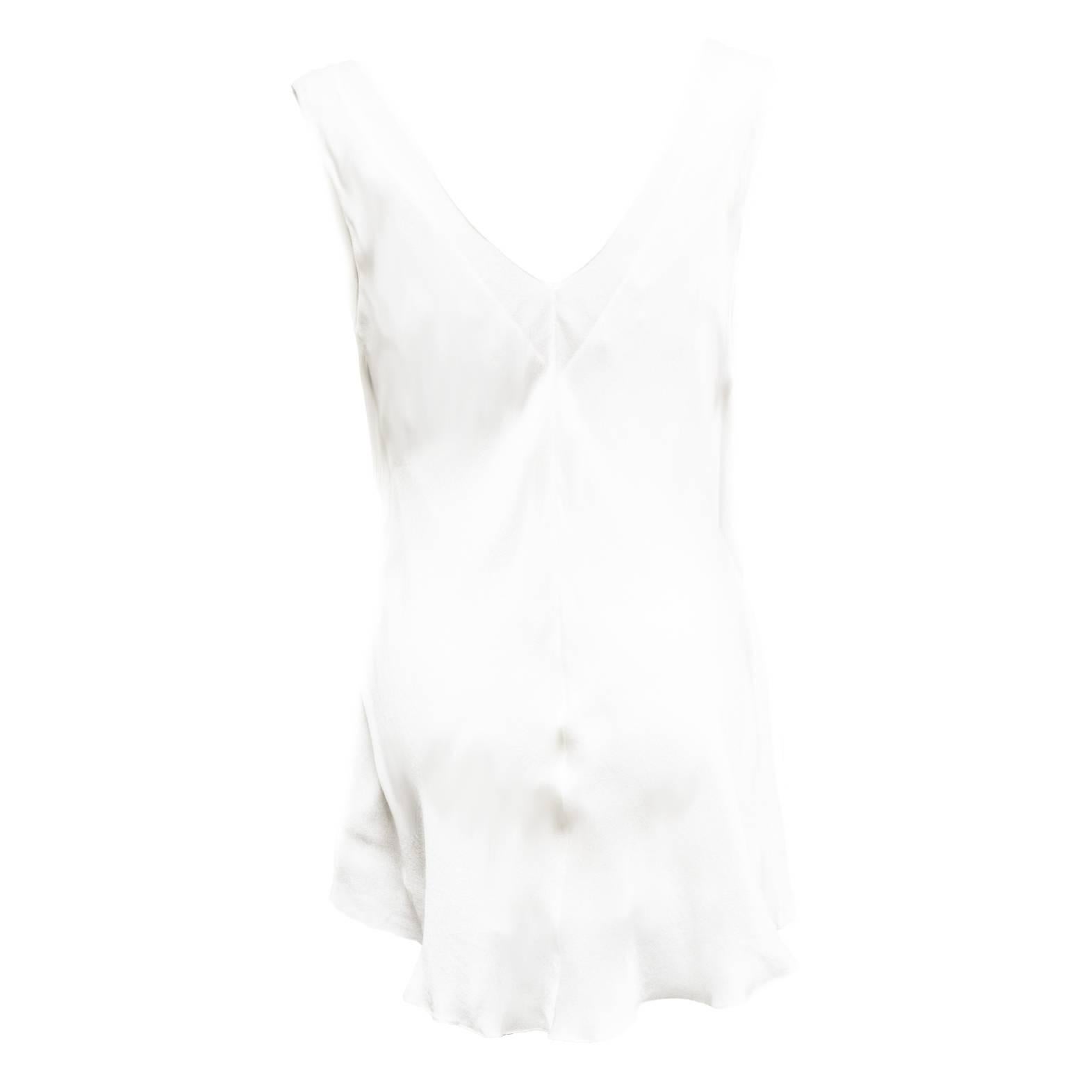 This elegant sexy Narciso Rodriguez Ivory draped evening blouse is an effortless going out piece. Made from 100% Silk this blouse layered and lined underneath adding luxury and motion to this piece. There is a coul like drape that is attached to