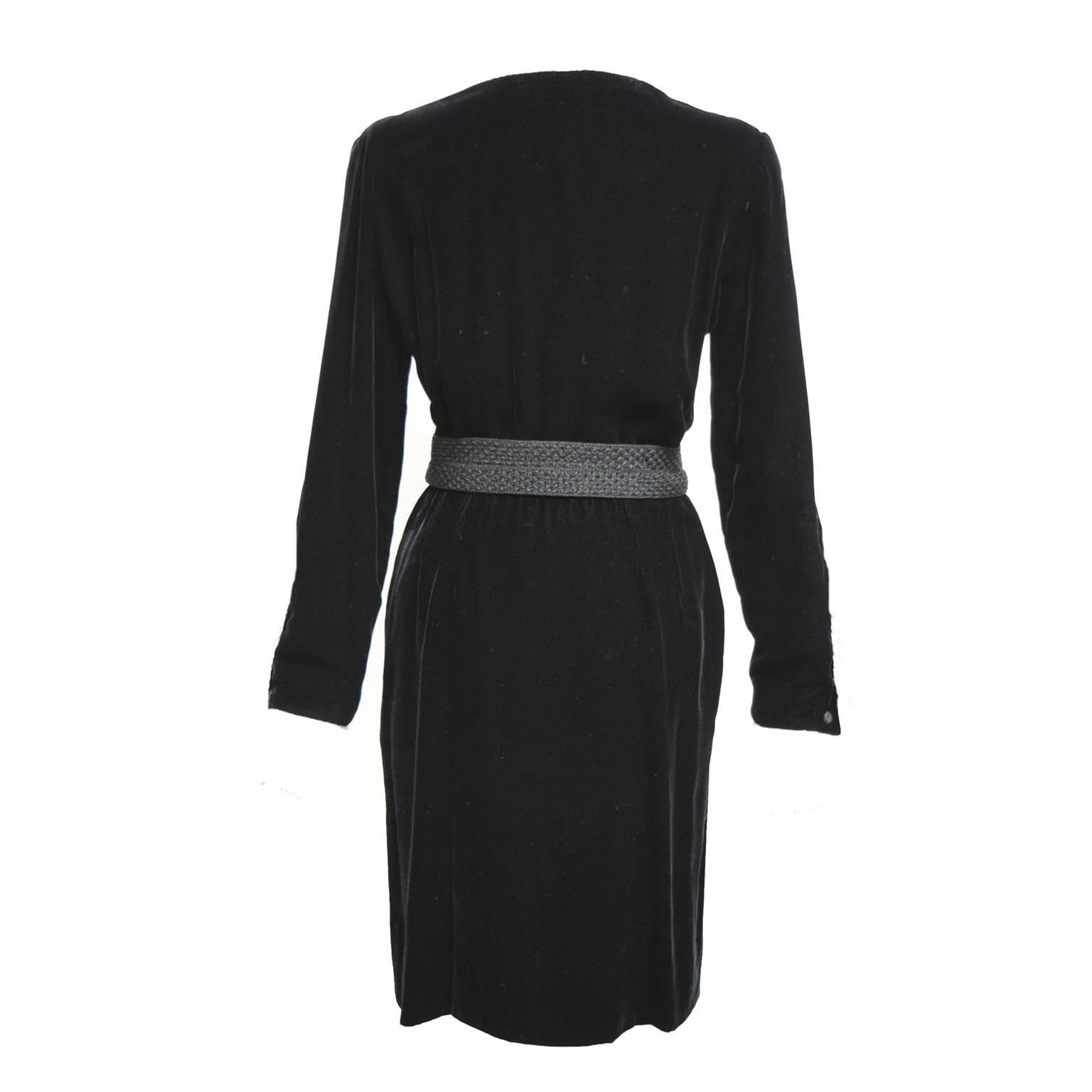 This fabulous Oscar de la Renta evening shirt dress is made from black silk velvet. This dress is fully lined and has white taffeta ruffled collar and sleeve cuffs. Tasseled and knitted waist belt. 