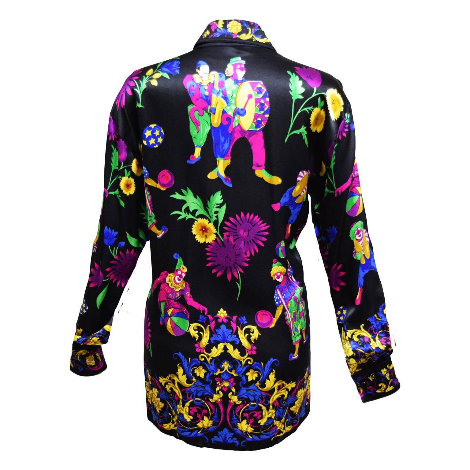 This Vintage Escada blouse is 100% black silk and has Mardi Gras printed characters. Button Closure. 