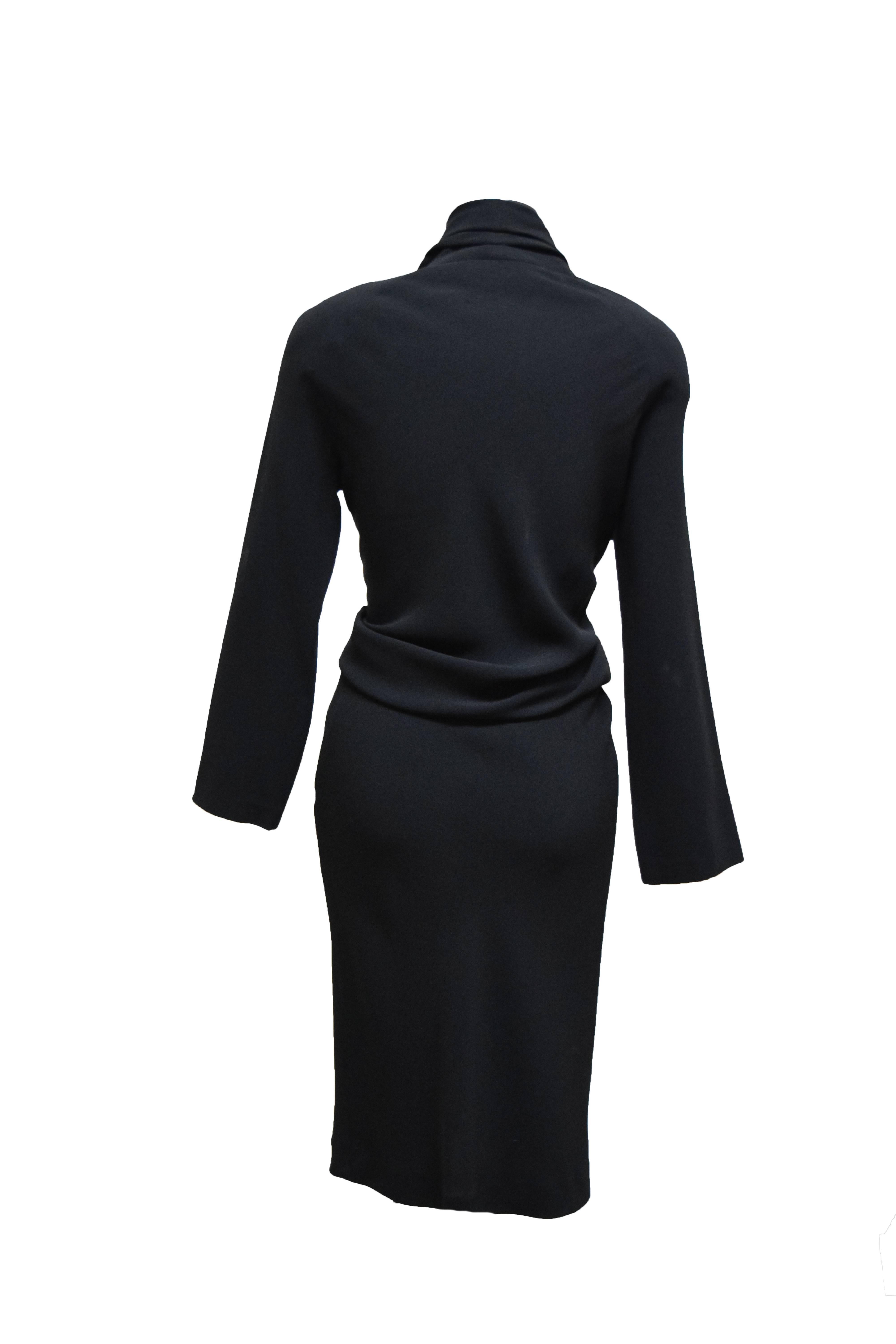 This Donna Karan Dress is a shirt waisted cocktail dress with a body-con skirt and long sleeves. The neckline is a button down, and has a slight v shape.