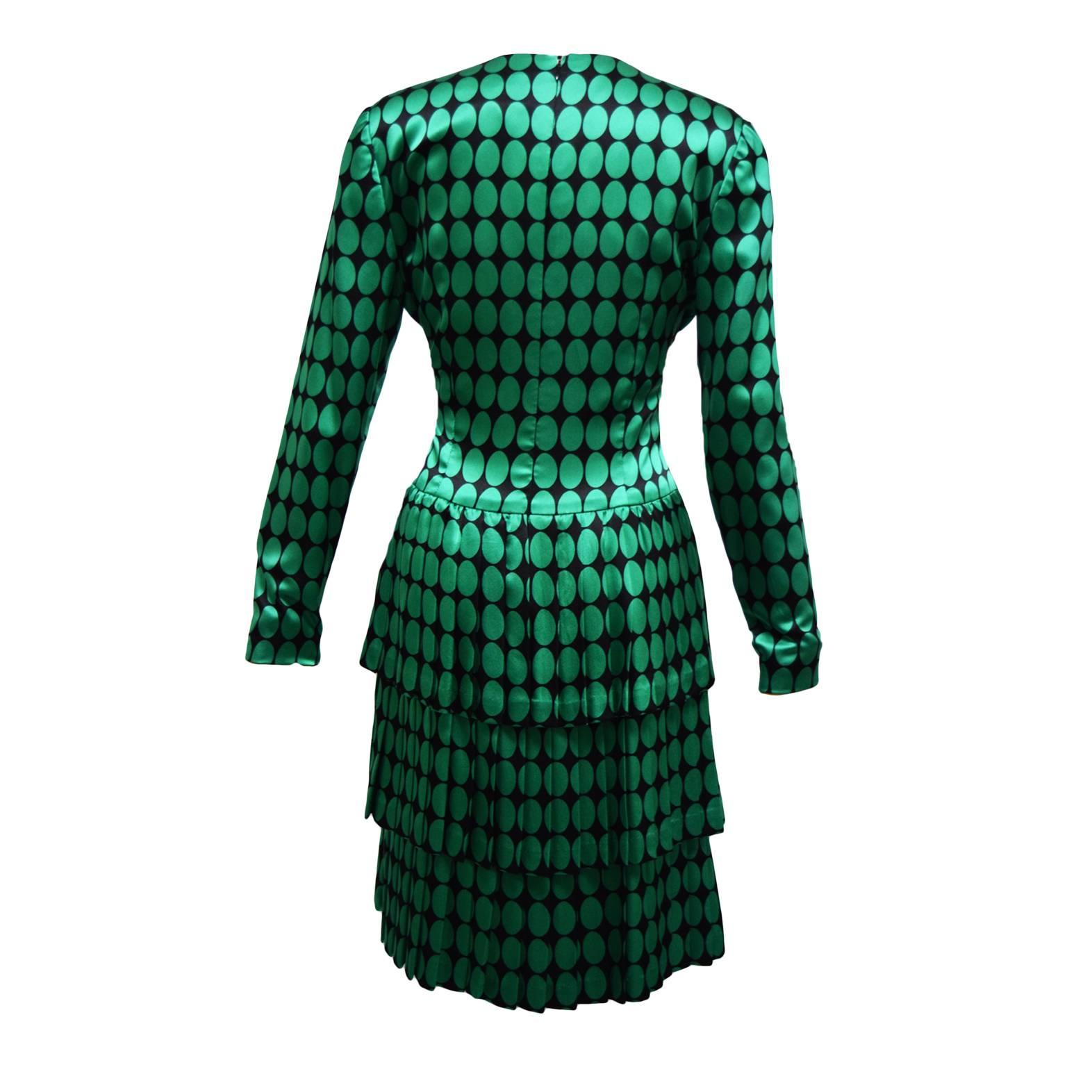 This beautiful Carolina Herrera  vintage sheath dress is black and green polka dot printed silk, and is long sleeved. The back is knife pleated giving it a cool layered old fashioned bustled illusion. 