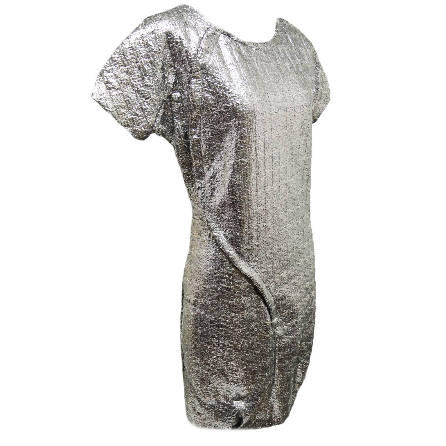 This Brian Reyes dress is a one of a kind. The dress is made out of a two faced fabric that has a soft inner hand and a metallic crinkled like texture creating this whole amazing aesthetic. The front of the dress has a snap opening and is alined to