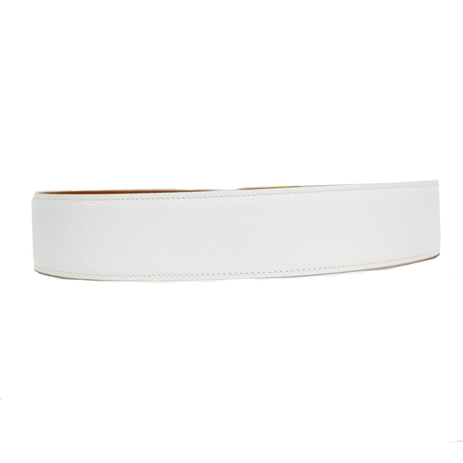 This Hermes Classic has a white leather belt base and a removable interchangeable silk yellow, green, white, and blue twilly with white printed stich details and the Hermes logo printed.