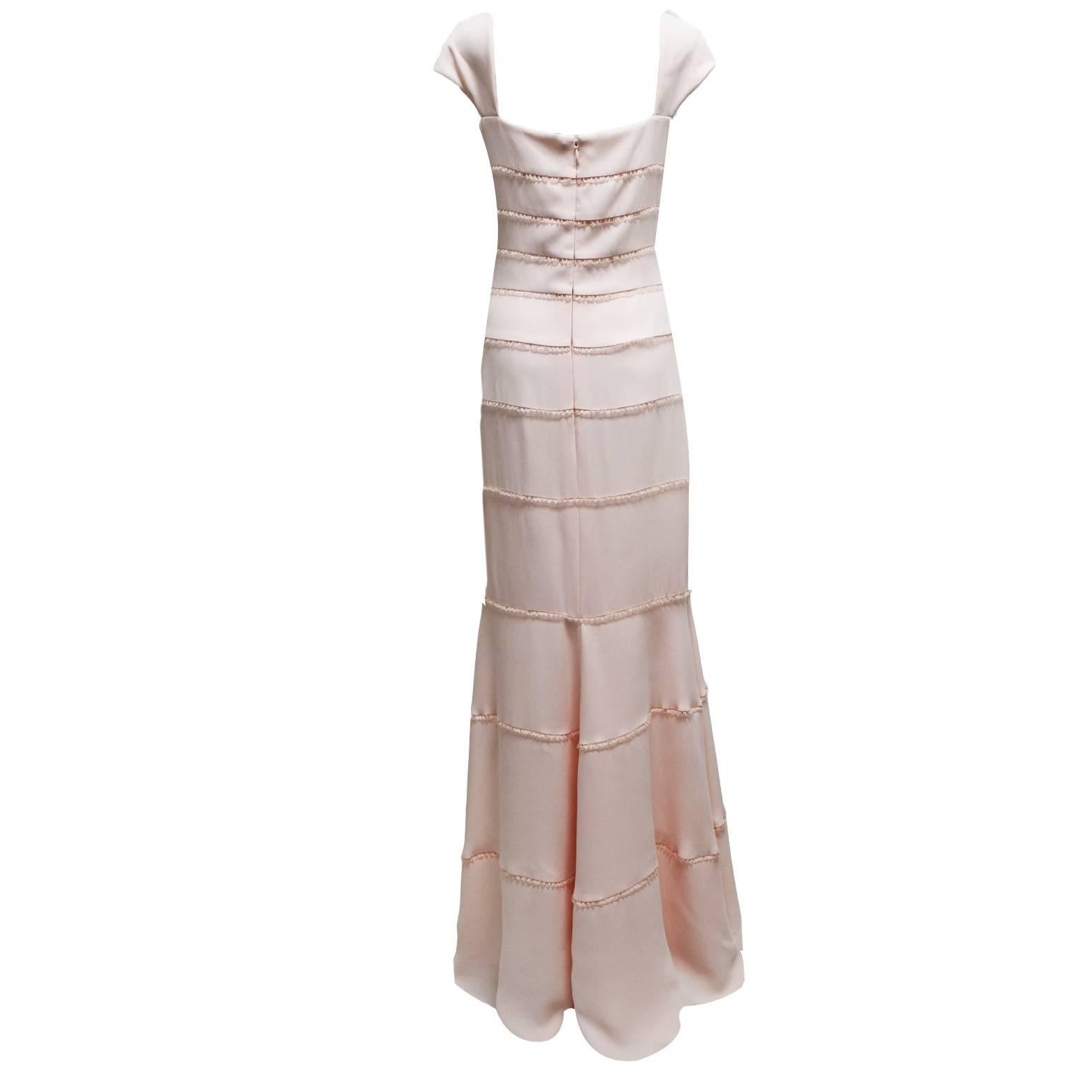 This beautiful Escada Couture label short sleeve sheath evening dress is made out of 100% blush dyed silk and has gathered sheer ribbon stripes all around the dress creating a delicate aesthetic. On the right side of the bust is located a detachable