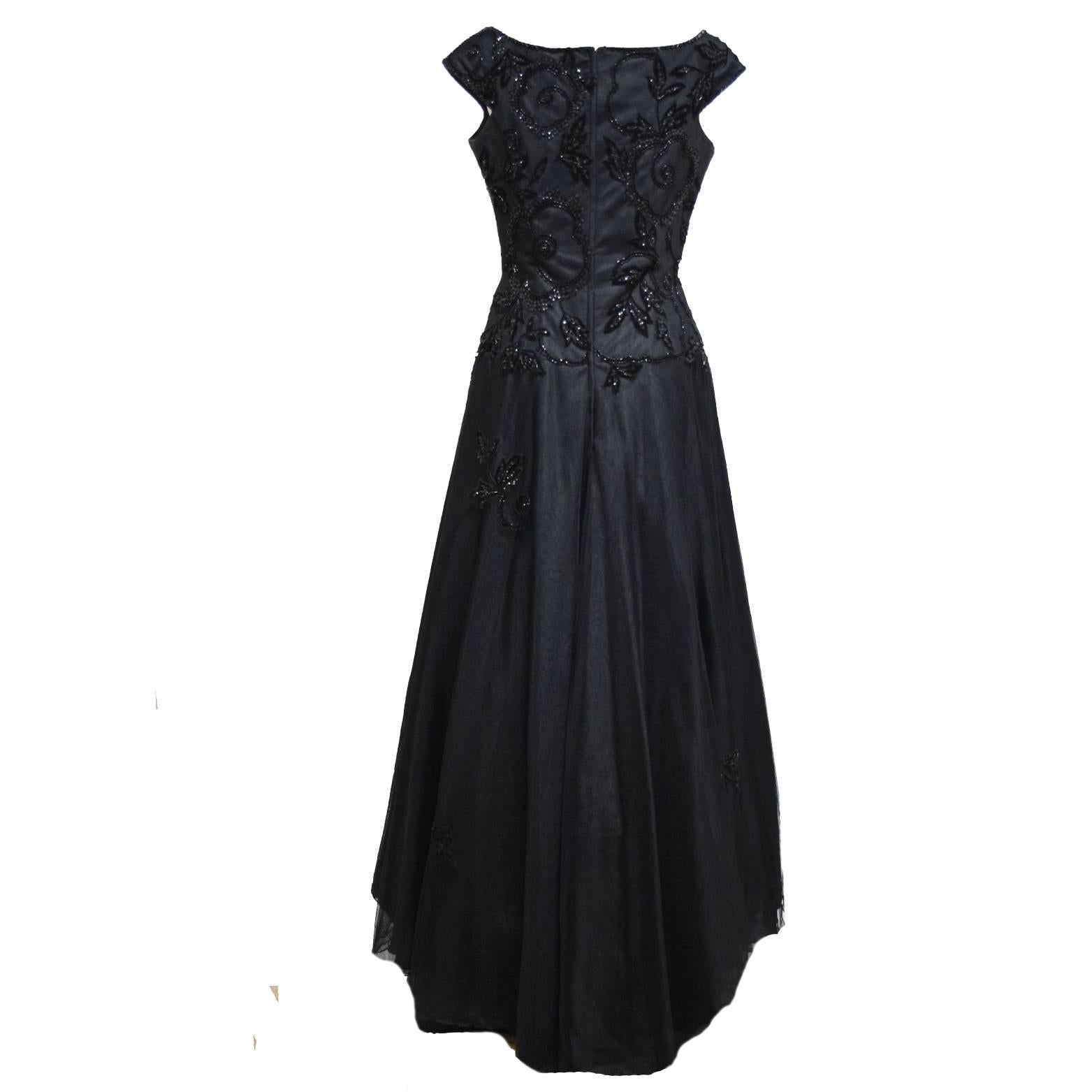 Liancarlo Black Evening Gown, Made with Three Layers of Black Tulle Adorned with Hand Sequin, Beading and Embroidered Vine of Roses on Bodice, Cap Sleeeve, Drop Waistline, Full Skirt Lined in Silk, Swiss Tulle Applied to the skirt as Fourth Layer