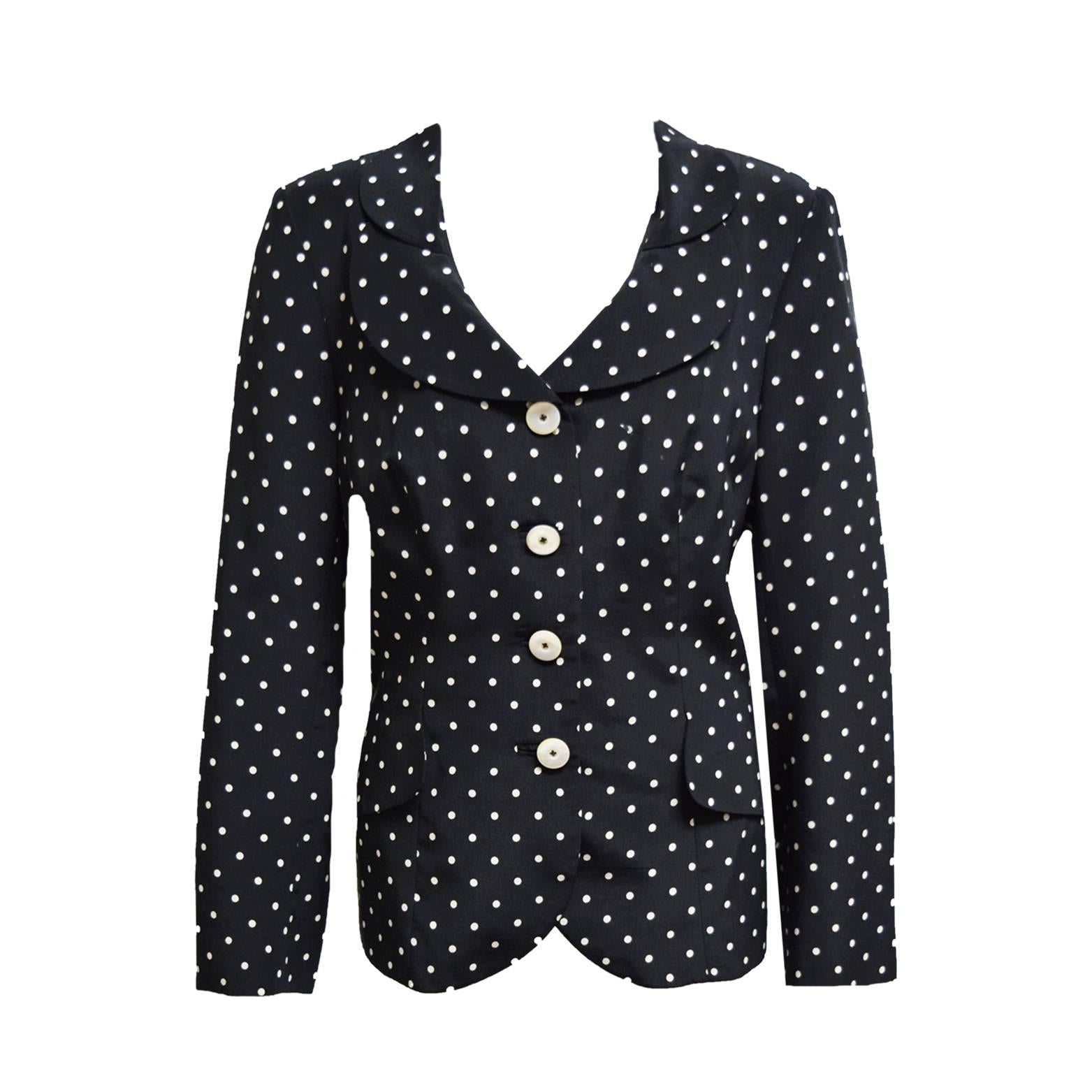 This amazing ensemble by Algo is made of 100% silk and is printed in black and white polka dots. The jacket is single lapeled and the skirt has  a back zipper. Both are fully lined. 