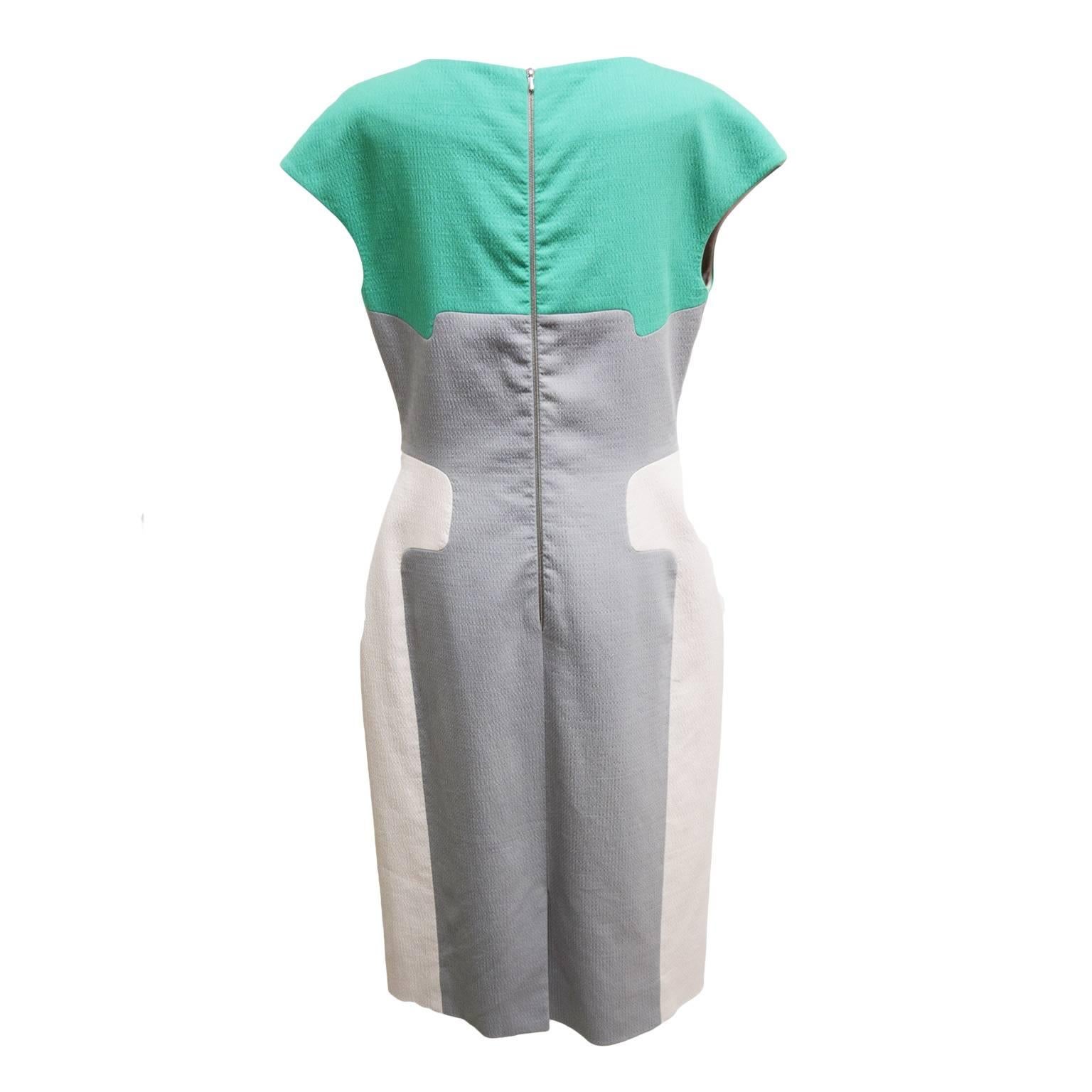 This dress by Lela Rose is a cotton, elastic, silk blend, and color blocked with grey, ivory, and mint coloration. The sleeves are short and the shaped colors allow for a slimming look. The dress also has a back zipped closure and is fully lined. 