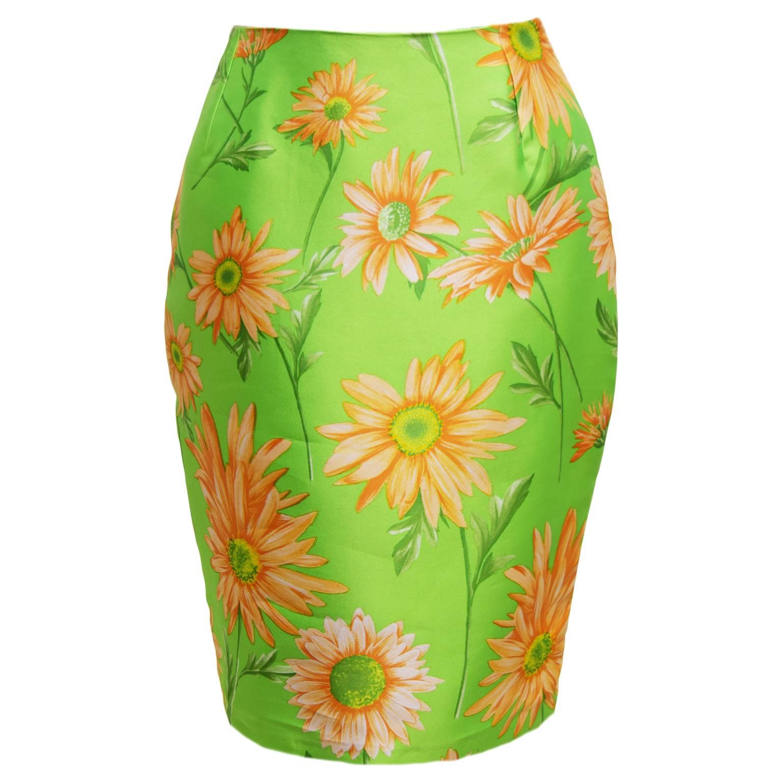 This Dolce and Gabbana skirt is a beautiful chartreuse, yellow, and orange daisy print, and is 100% Silk. It has a back zipped closure, and a structured feel to it. 