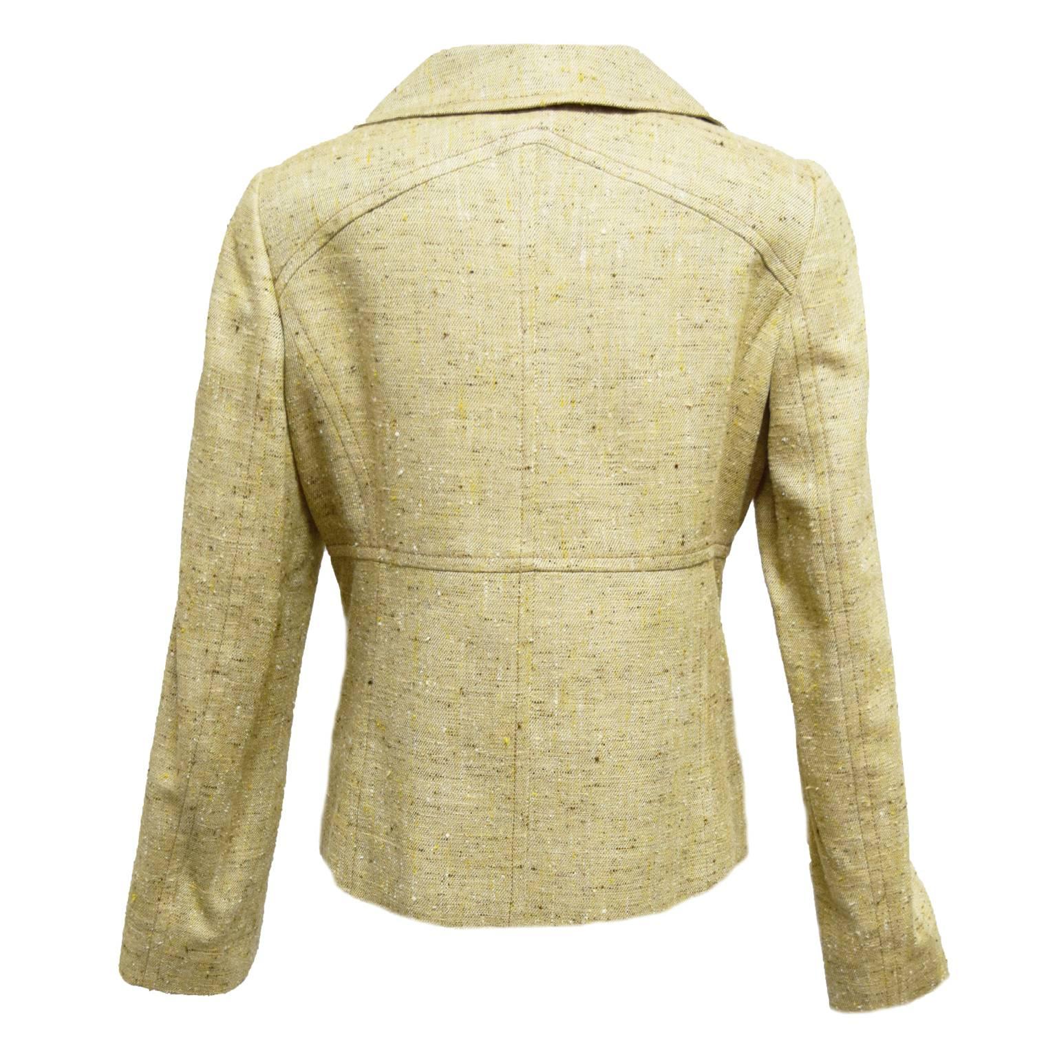 This Valentino jacket is a butter beige yellow twill and is fully lined. It is single lapeled and tortes shell buttons for a nice contrast. There is a dart along the waist to break of the body for a more slimming look and two side pockets. 