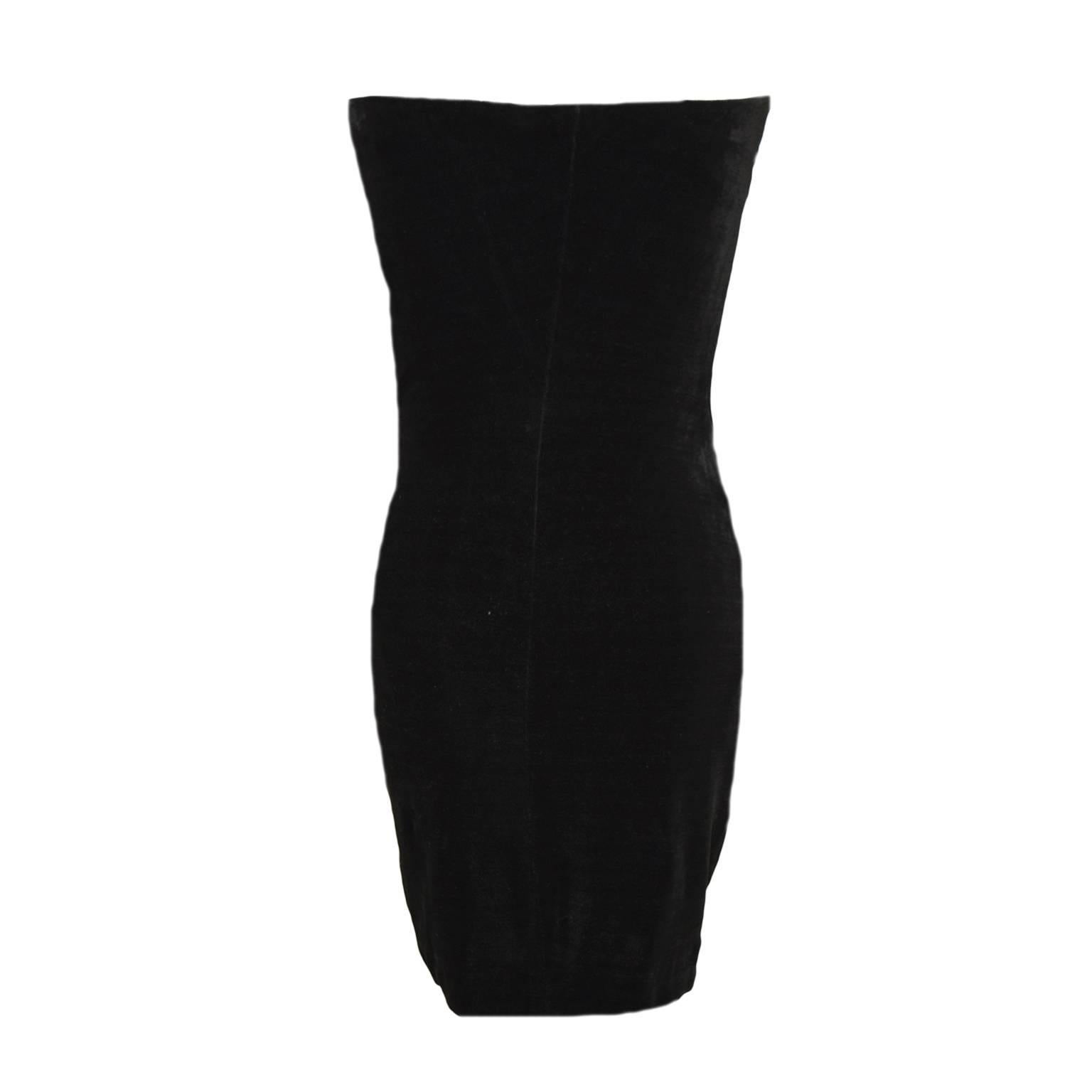 This dress by Donna Karan is a vintage find. Made out of black velvet, this dress is a bodycon cocktail dress. There is a lace body suit with snapped closures lined on the inner part of the dress.
