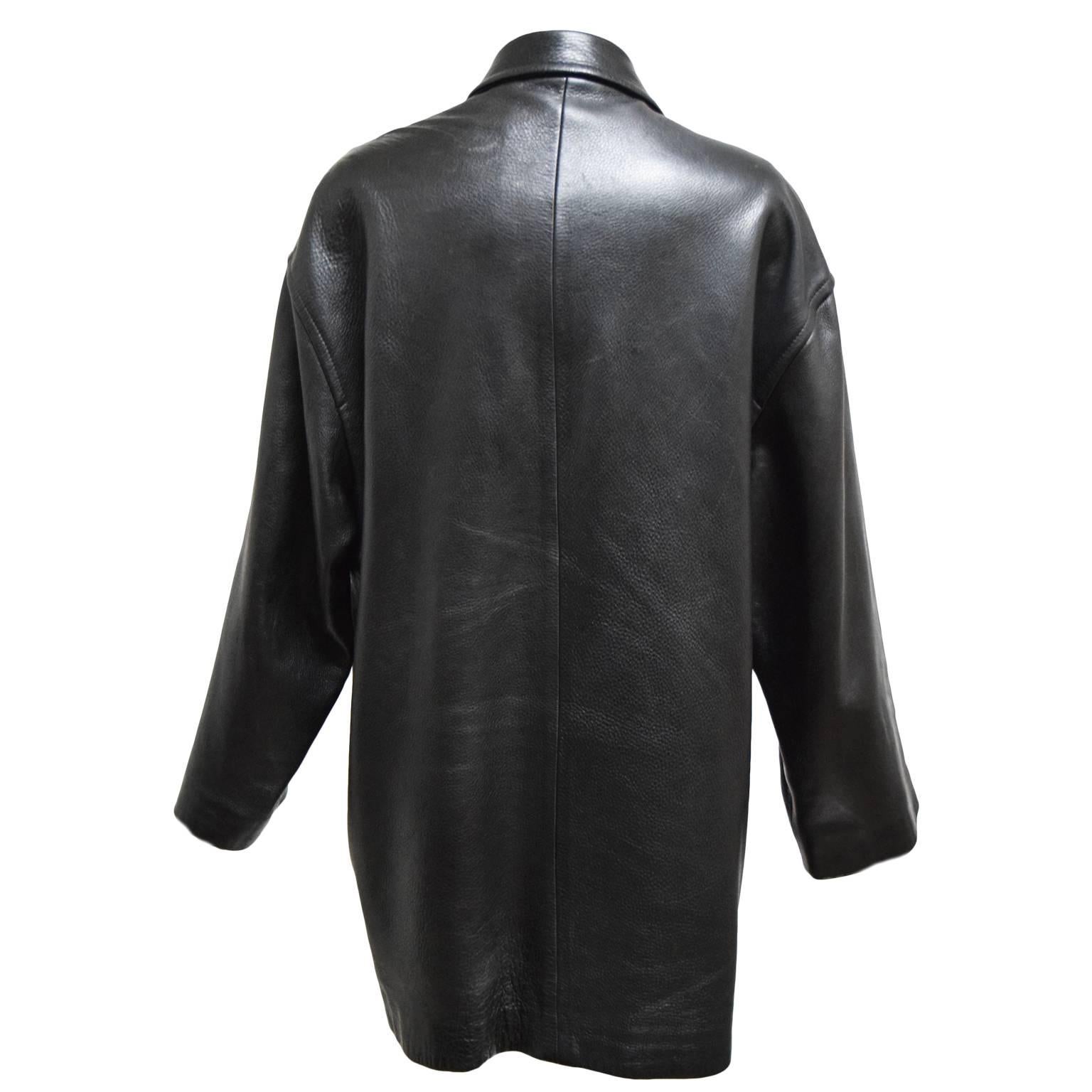 This beautiful vintage leather jacket by Donna Karan is made from 100% black leather and is lined in rich silk. There are button closures, two side pockets and a collar. It is a size petite however it can fit up to a size 10. 