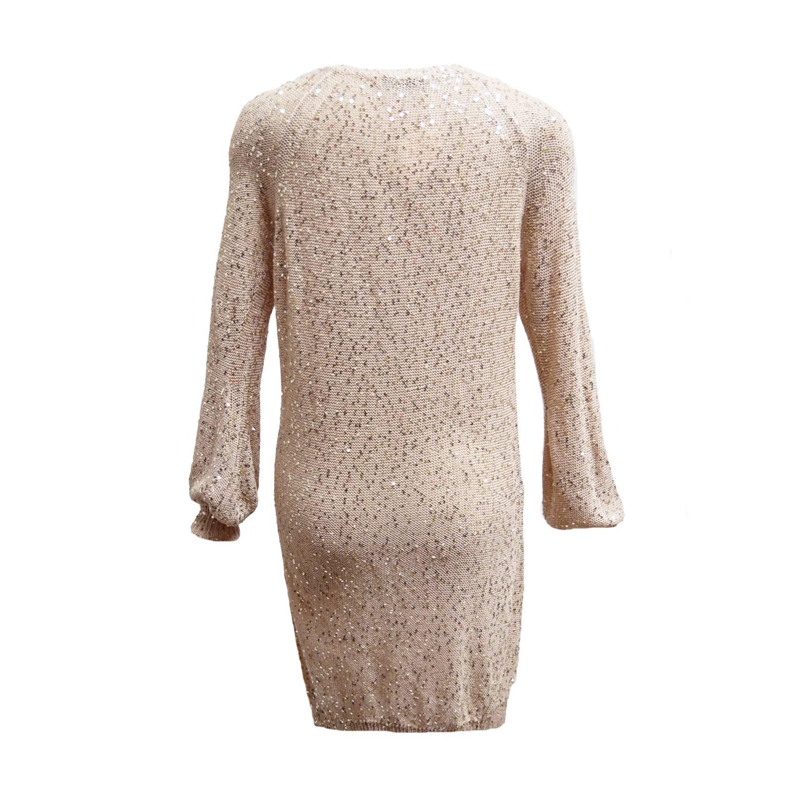 This Stella McCartney sweater dress, is a silk, wool blend and is a beautiful rich blush color. The sleeve cuffs are ribbed and all over the dress are hand sewn metallic silver sequin embellishments.  