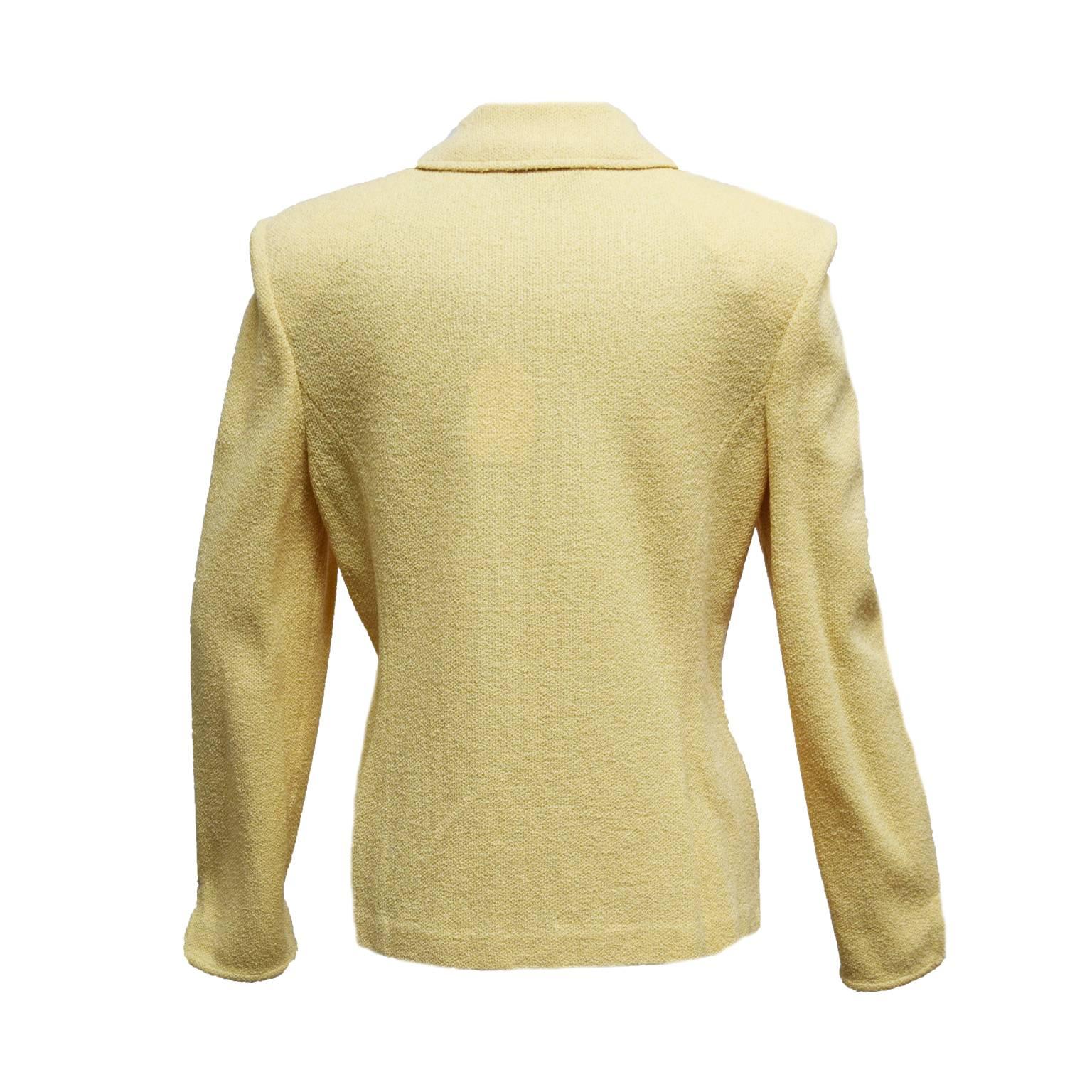 This St. John jacket is a butter yellow, and is long sleeved. The buttons are a black and gold creating a nice touch to the jacket.