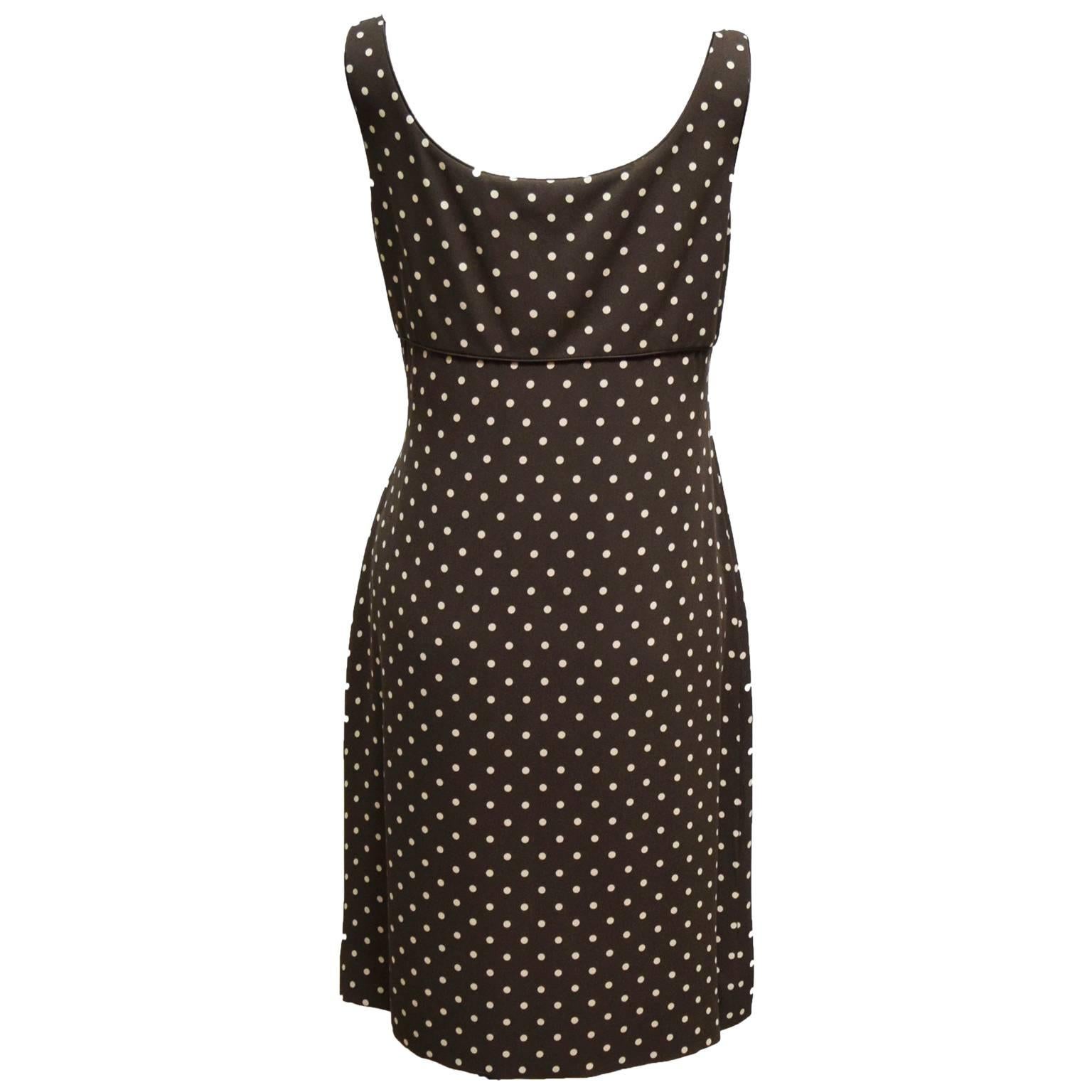 This Carolina Herrera dress is great for summer. It is made out of 100% silk and is a brown and cream polka dot print. The Neckline is a deep V-neck with a silk floret embellishment. The dress has a side zip and is fully lined.