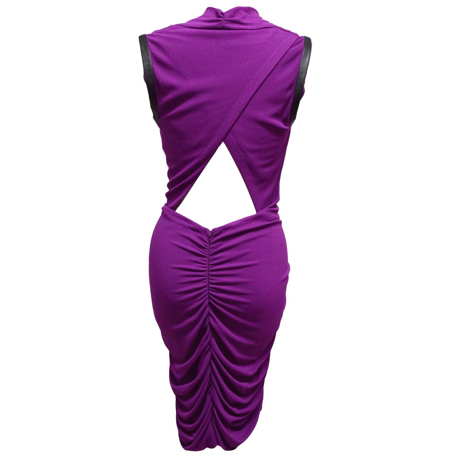 This dress by Yigal Azrouël is a polyester stretch blend dress in barney and is a bodycon shape with hip gathers. The neckline is a cowl neck, and the back is cutout. Lastly there is leather trimming on the sides of the shoulders. 