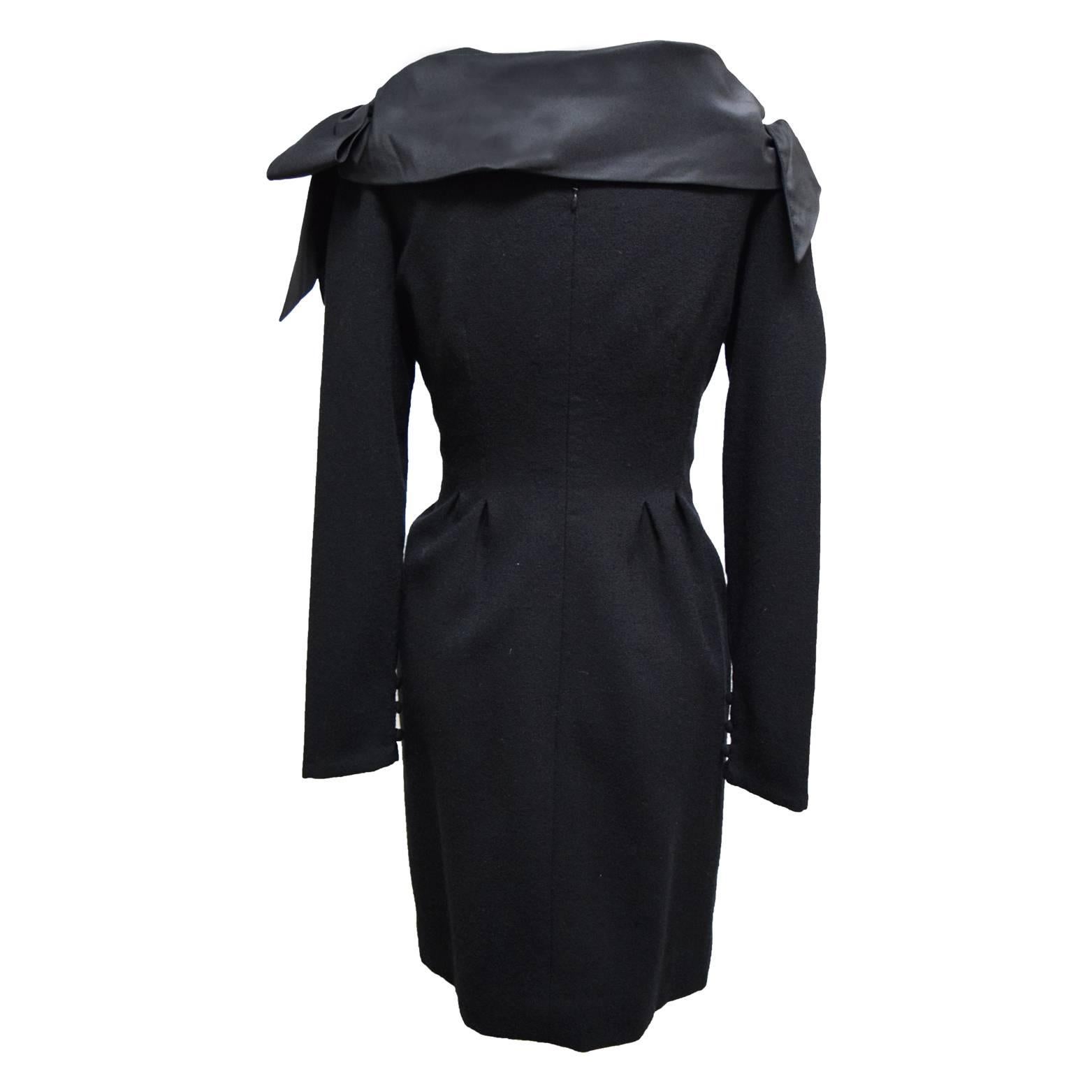 This Bill Bass dress is a beautiful work of art. It is made from 100% black dyed wool and it is long sleeved with button embellishments. The neckline of the dress is a slight plunging neckline and it is covered in handmade taffeta bows.