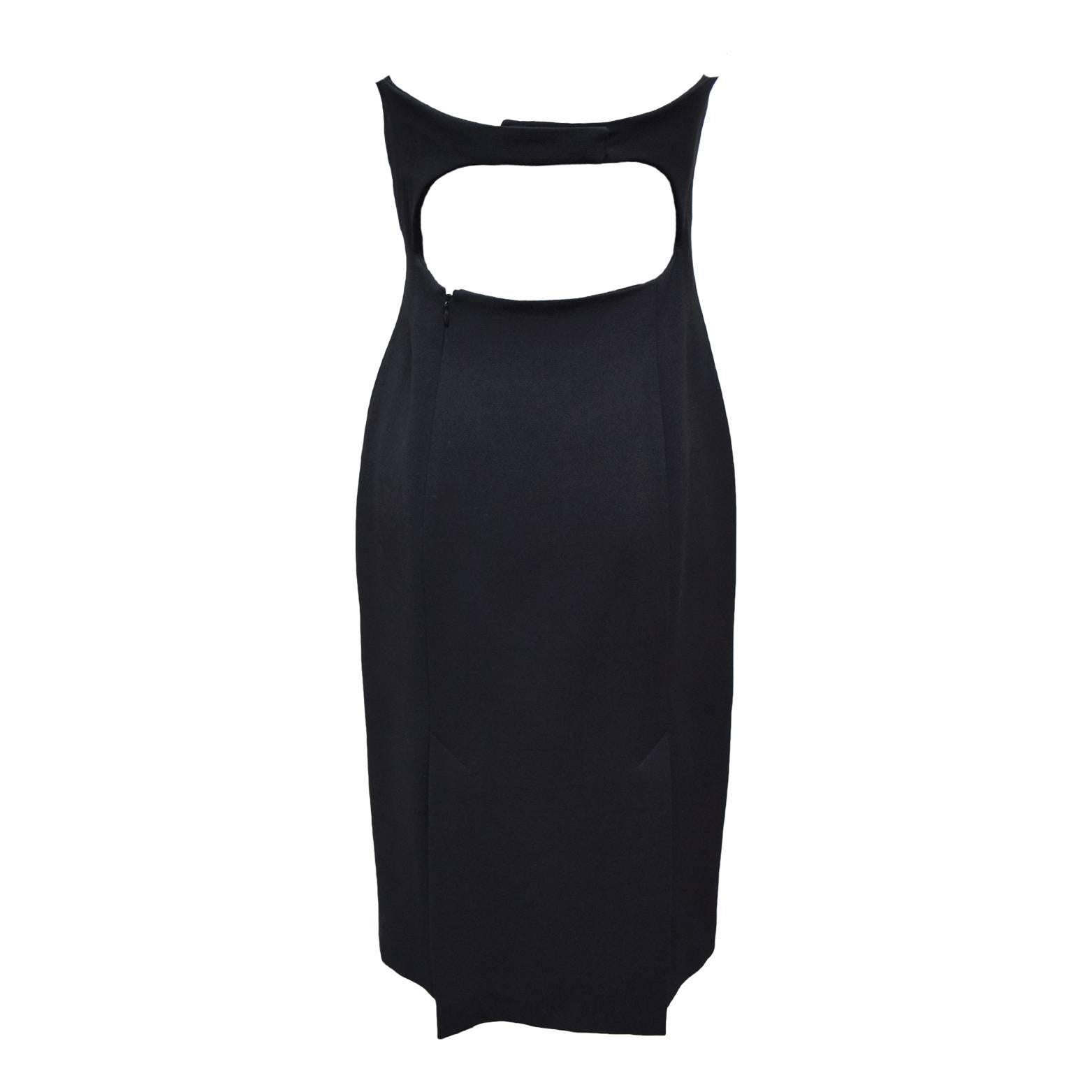 This elegant dress by Charles Chang-Lima is a strapless dress made out of black wool and is fully lined in silk. The neckline is a scoop-like neckline and has a freshwater pearl at each end. The back has a cutout detail and zips from a side panel in
