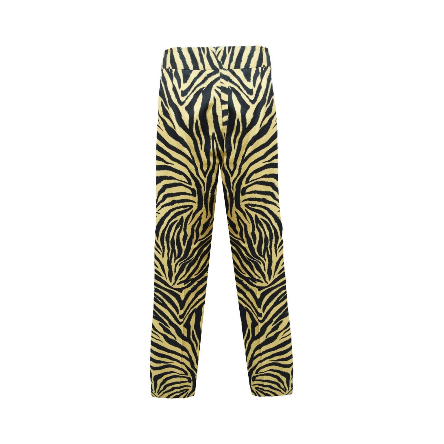 These pants by Carolina Herrera are a off yellow and zebra print. The leg of the pant is slim and they are 100% cotton. The side of the pants have a zipped closure and eye and hook 