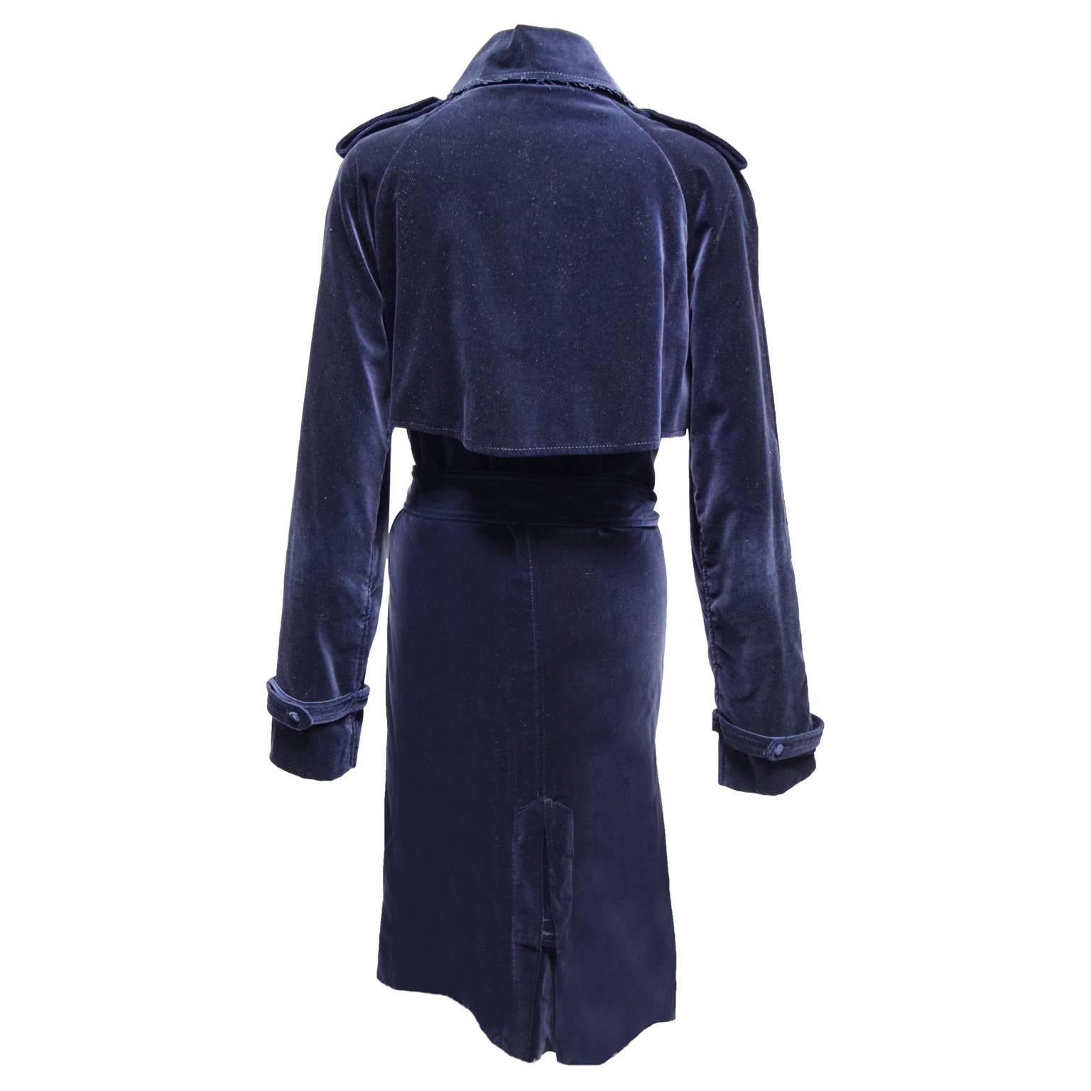 This luxurious trench by Lanvin is made from a rich navy velvet and is double breasted. The waist comes with a tie and the jacket has button closures, the jacket hits right under the knee and the sleeves can be cuffed. 