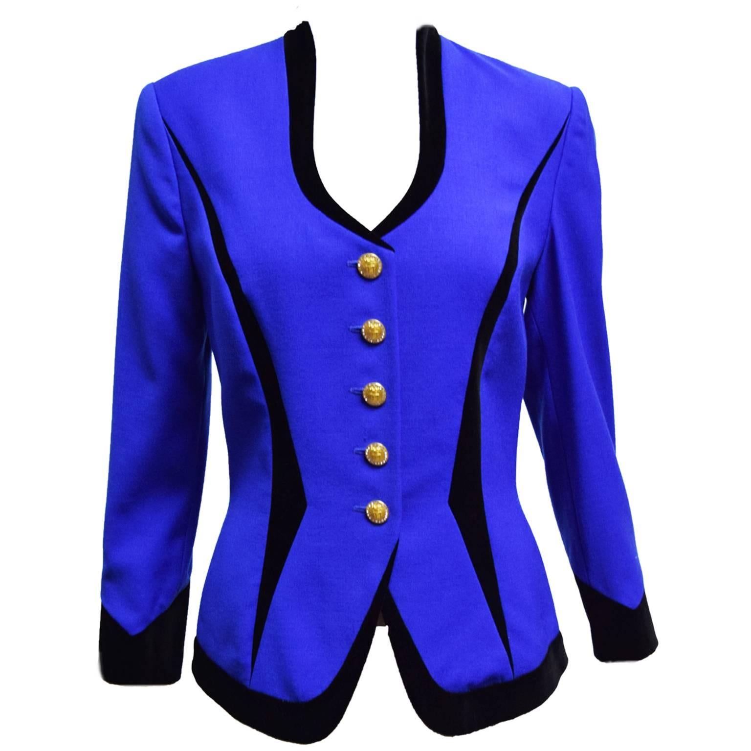 This Escada two piece skirt is a wool and velvet blend. There are velvet panels creating a slimming look. The jacket has gold button closures and is lined in silk. 