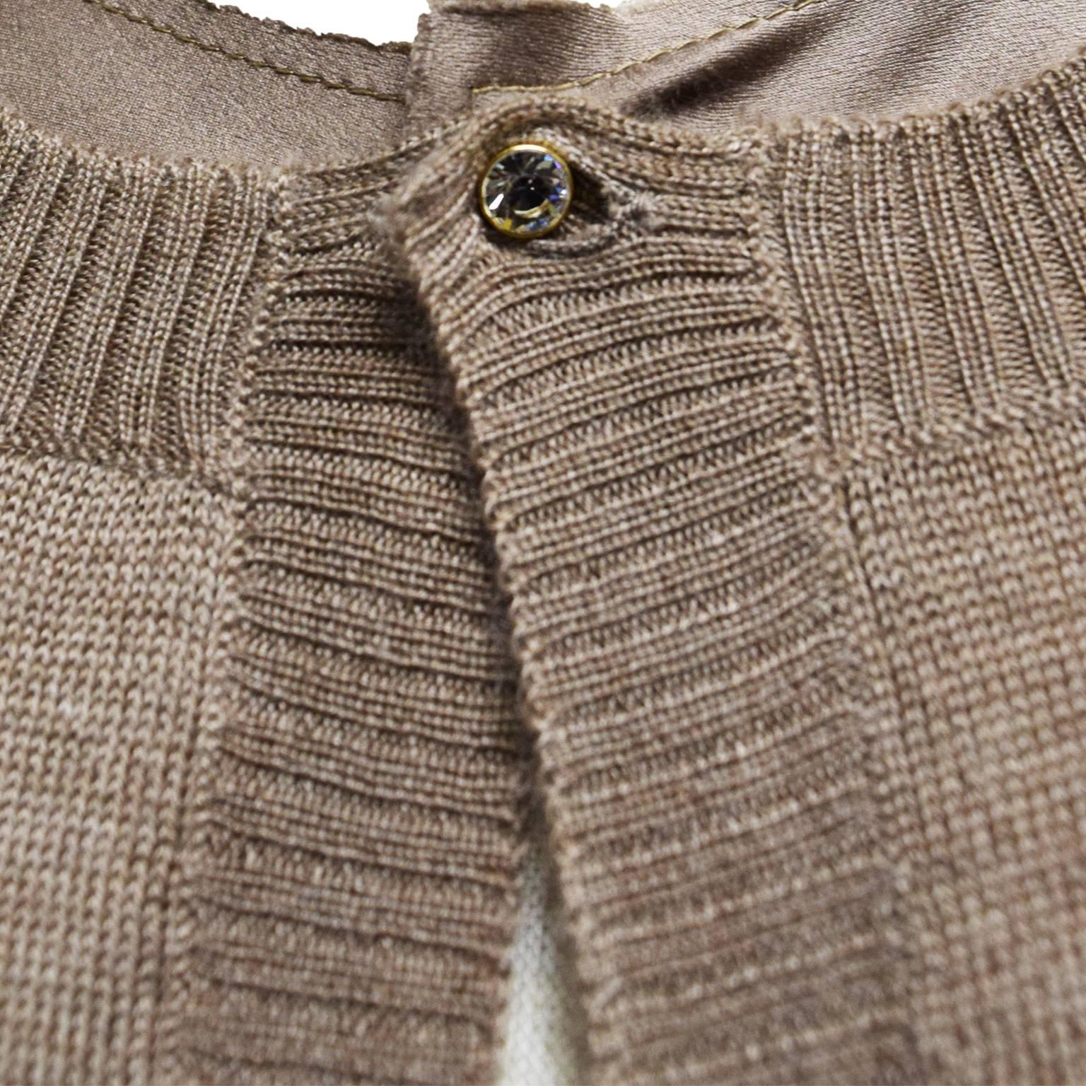 This beautiful sweater and vest duo is a one of a kind. This ensemble is made of silk and cashmere. The button is made from a Swarovski crystal.  