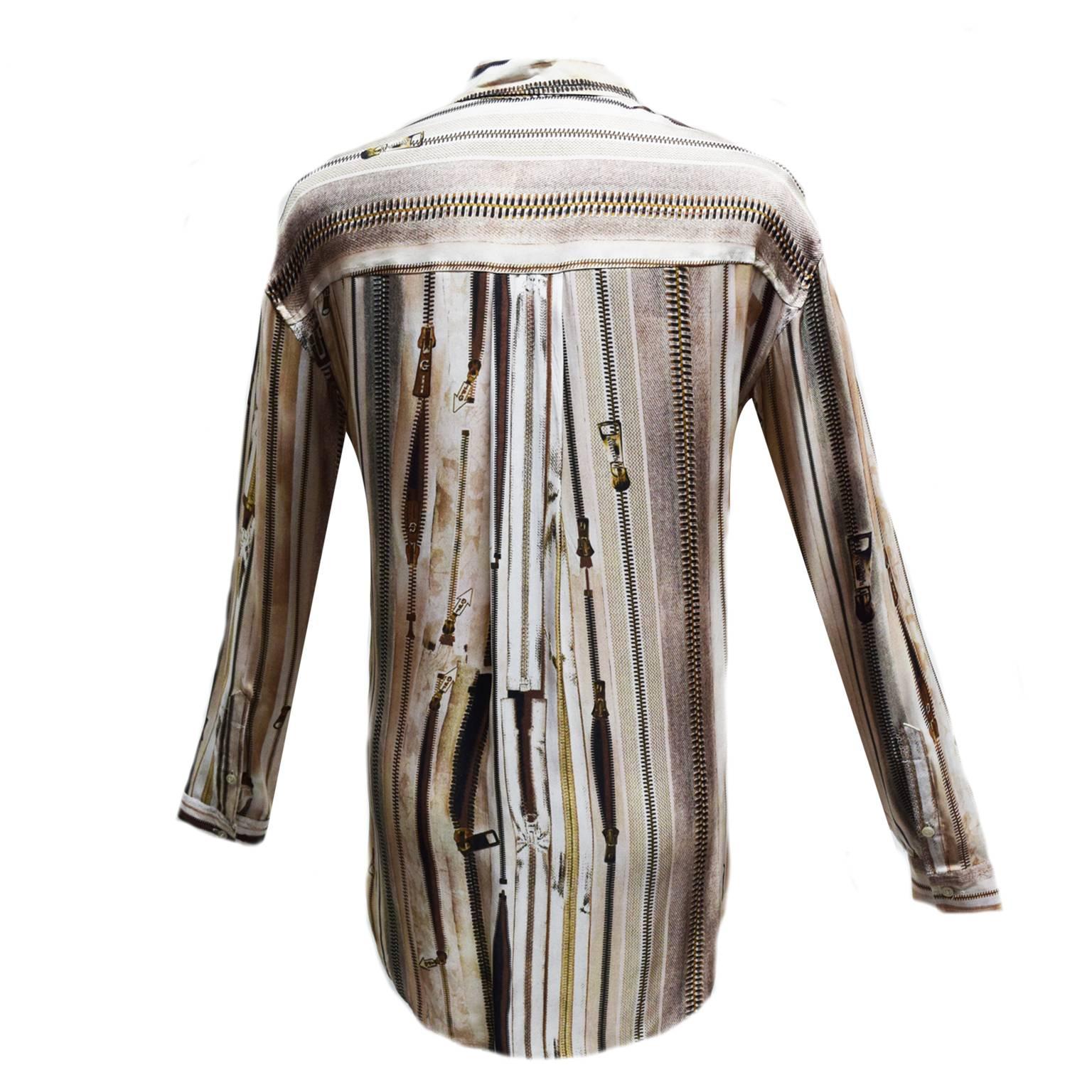 This Jean Paul Gaultier blouse is a monochromatic neutral zipper print and is long sleeved.  The front has a zipper detail and is 100% silk. 