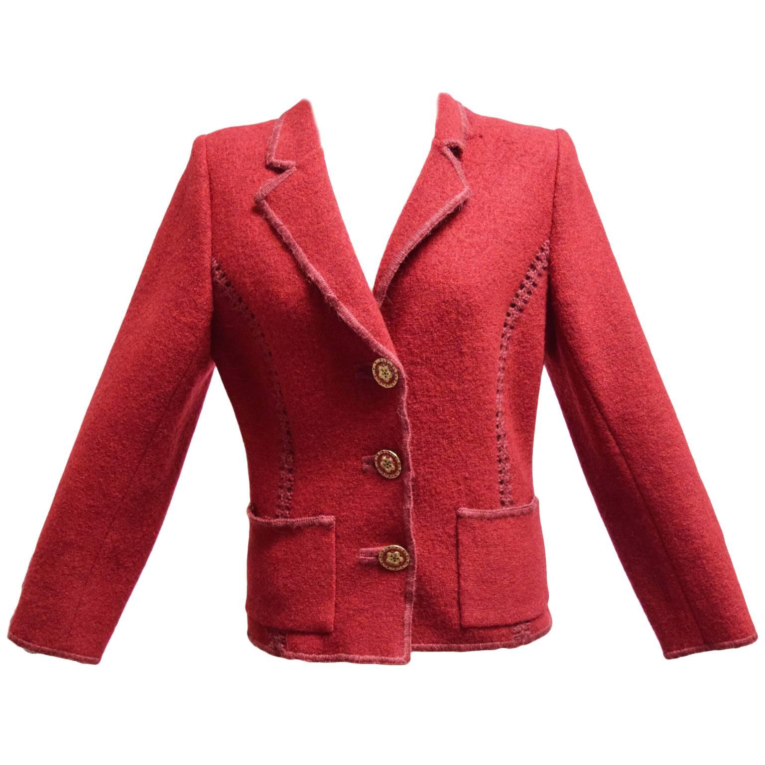 This beautiful two piece is a rich merlot color. The jacket is made out of 100% wool, while the shell blouse is a stretch silk, and wool blend. The Jacket has gold and red button closures with an intricate design and finish. It also has stitching