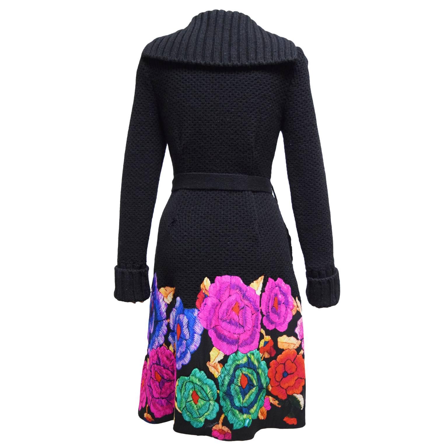 This one of a kind sweater topper by Roberto Cavalli is made from 100% wool and has a multicolored silk floral border. The waist is belted and has a detachable belt and shawl collar. 