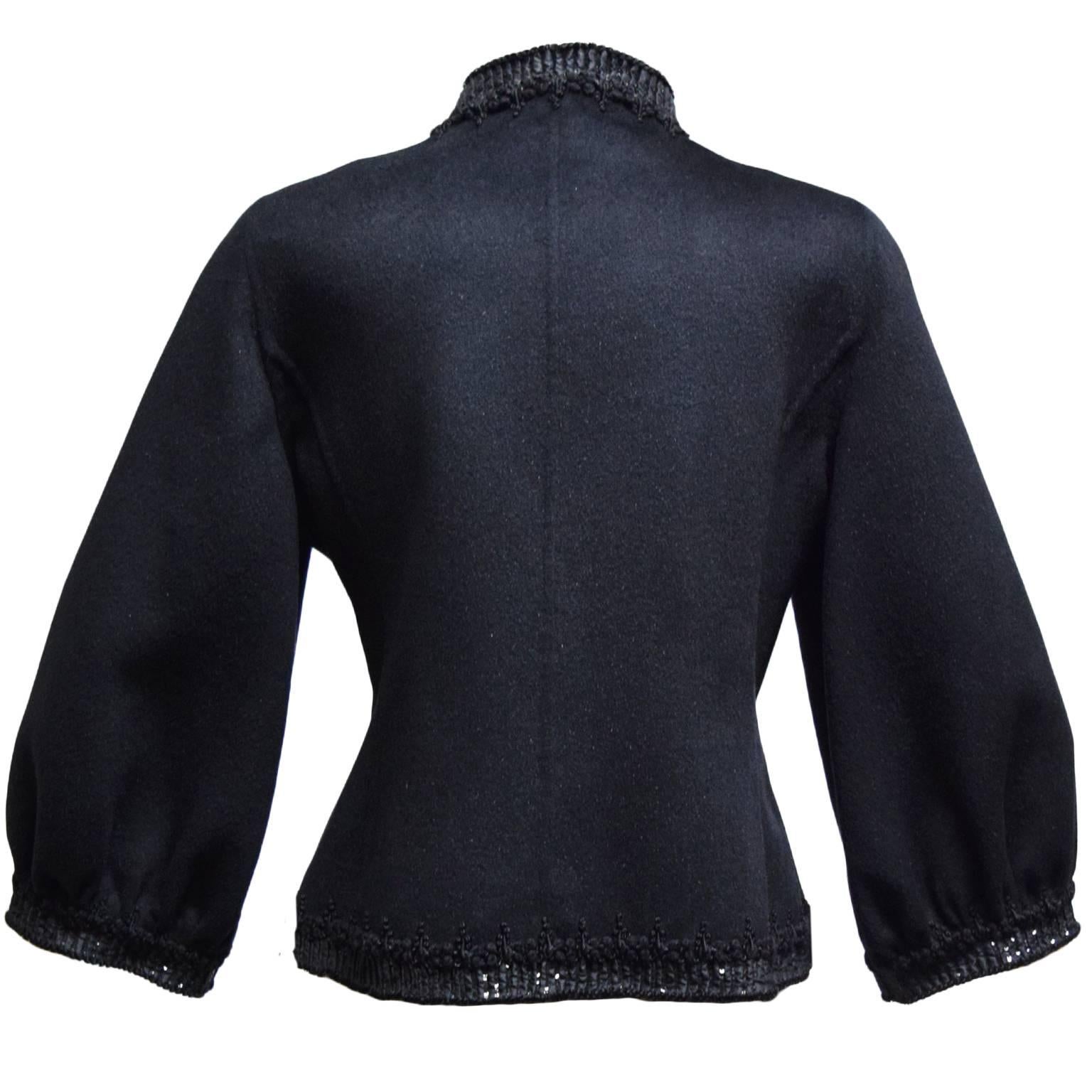 This Oscar de la Renta jacket is 100% wool with silk trapunto embroidery used as a elegant border. It is double faced with a slight mocked neck and bishop sleeves. 