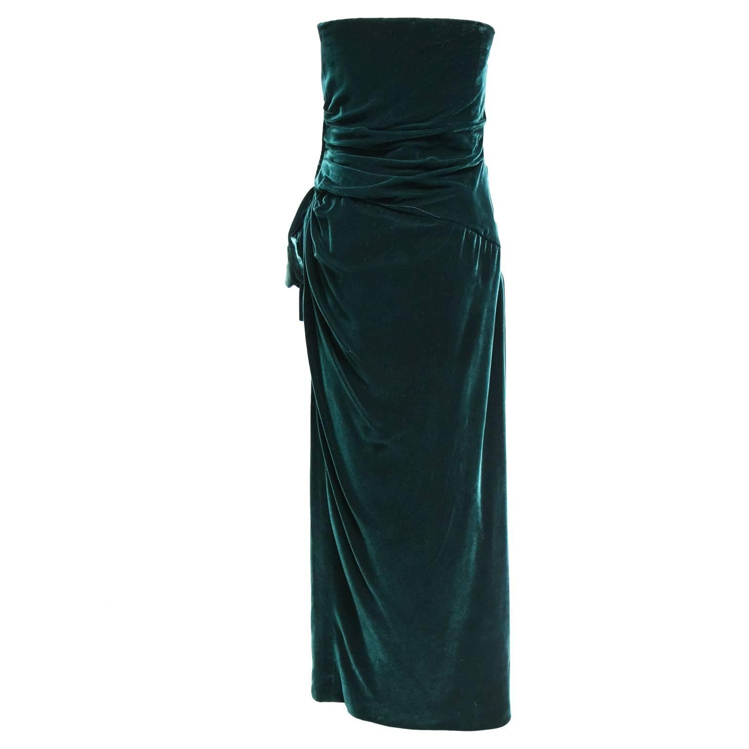 This beautiful dress by Victor Costa is made of a beautiful emerald green velvet which is perfect for any holiday event coming up this year. The bodice is gathered creating a draped look and the front of the dress has a side sash embellishment.  