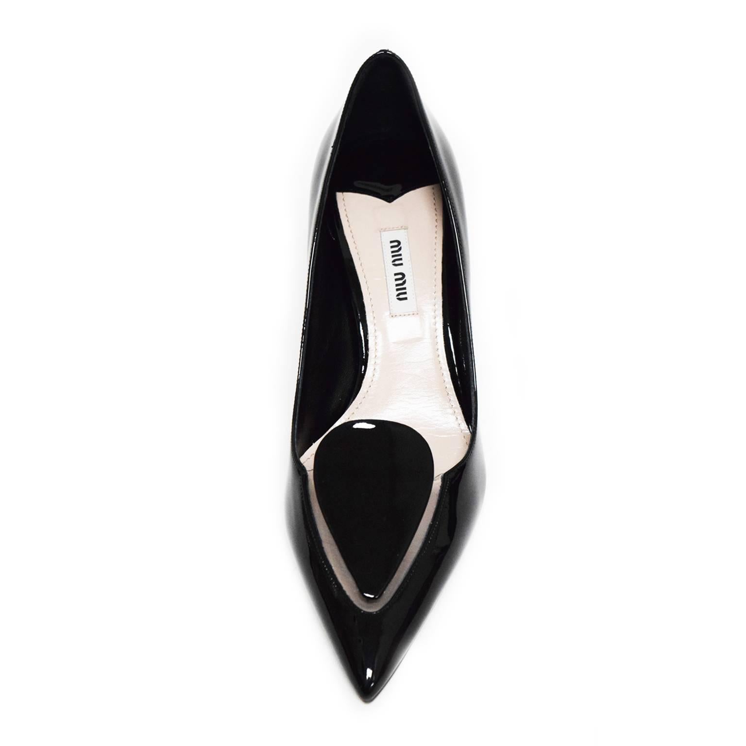 These Sleek and Classic Miu Miu Kitten Heels are incased with powerful black patent leather, with a clear PVC cut out located on the toe box to create  a slimming sleek jewel like shape. The lining is fully covered in blush soft leather and has the