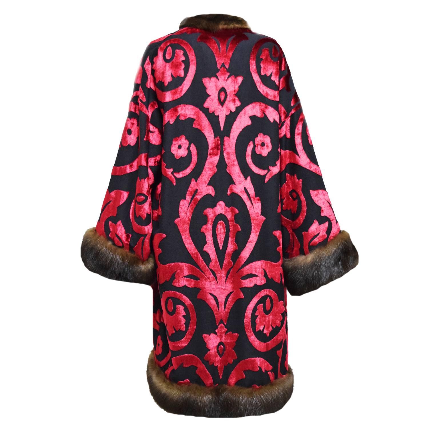 This exquisite piece is one of a kind. Made with silk, wool, and vicose, and is double lined with silk and silk chiffon. This evening duster is made up of a intricate florentine design and gives off a very sheen look. Sable Trim creates a luxurious