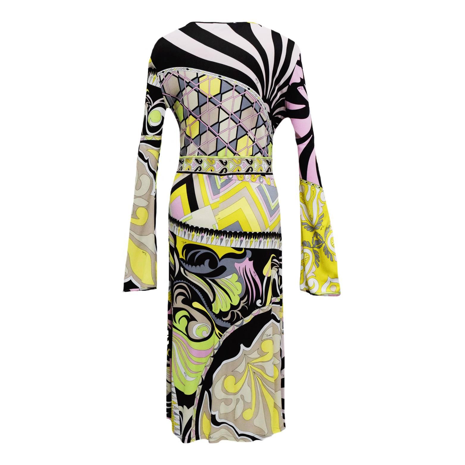 This fabulous dress is great for almost any occasion. Classically printed in Pucci's signature print and coloration. This dress is knee length and 100% Rayon. Slight trumpet sleeve and deep v-neckline. 