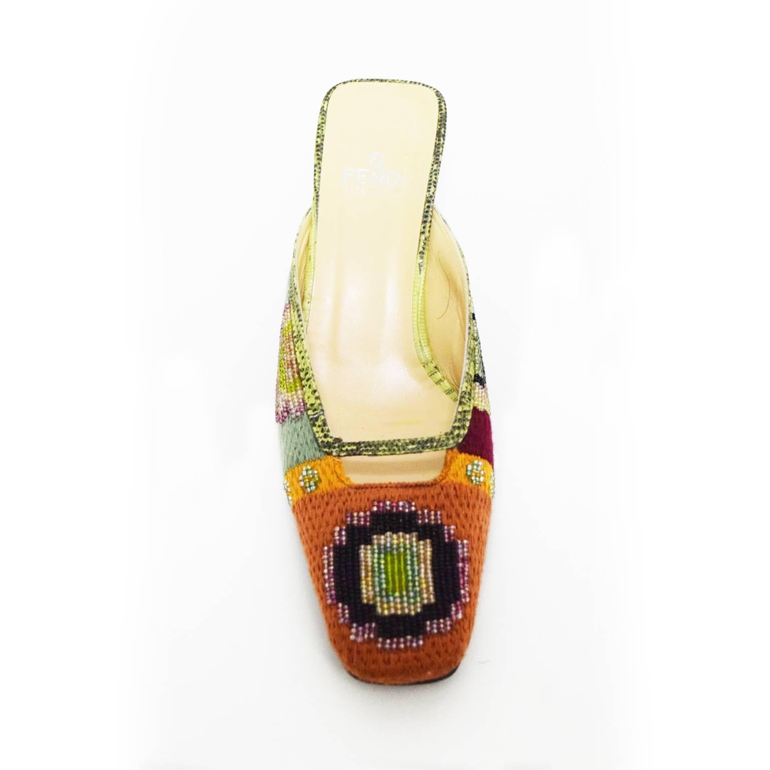 This Fendi hand beaded Mule is any fashion fanatic's collector's piece. In replica to the Fendi handbag, these shoes have a knitted overlay and glass bead embellishment. Reptile leather trim and heel add a unique touch. 