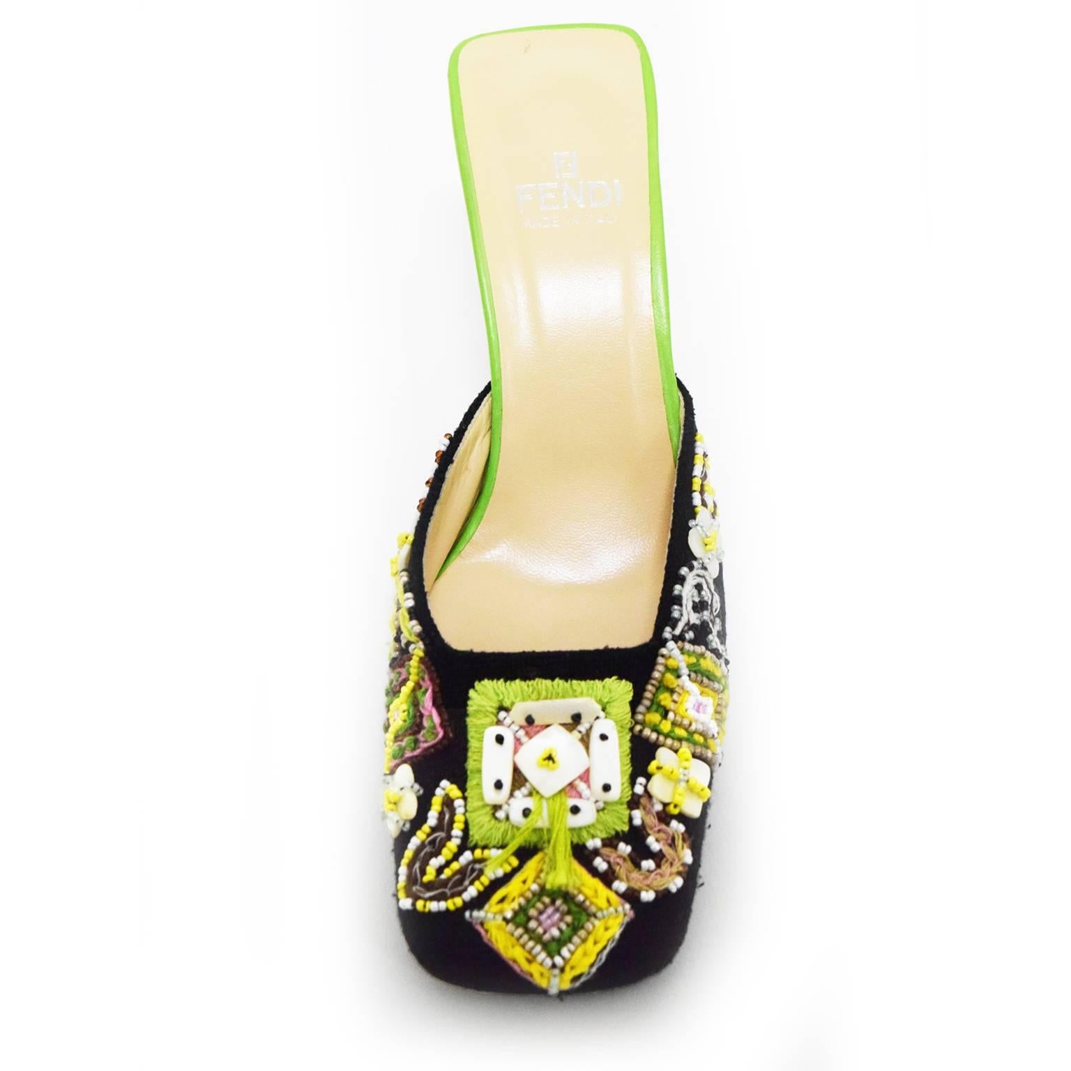 This Fendi hand beaded Mule is any fashion fanatic's collector's piece. In replica to the Fendi handbag, these shoes have a canvas overlay and glass bead and shell embellishments. The heel of the mule shoe is a vibrant green leather which gives it