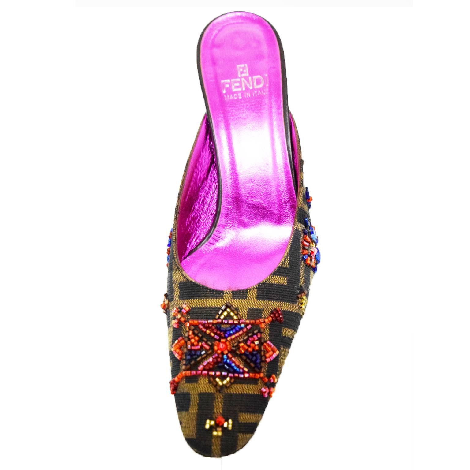 These collectable Fendi Zucca Print Mules are printed fabricated with glass beaded embellishments. Printed with the signature Fendi logo and has a 3 inch heel and iridescent leather sole. 