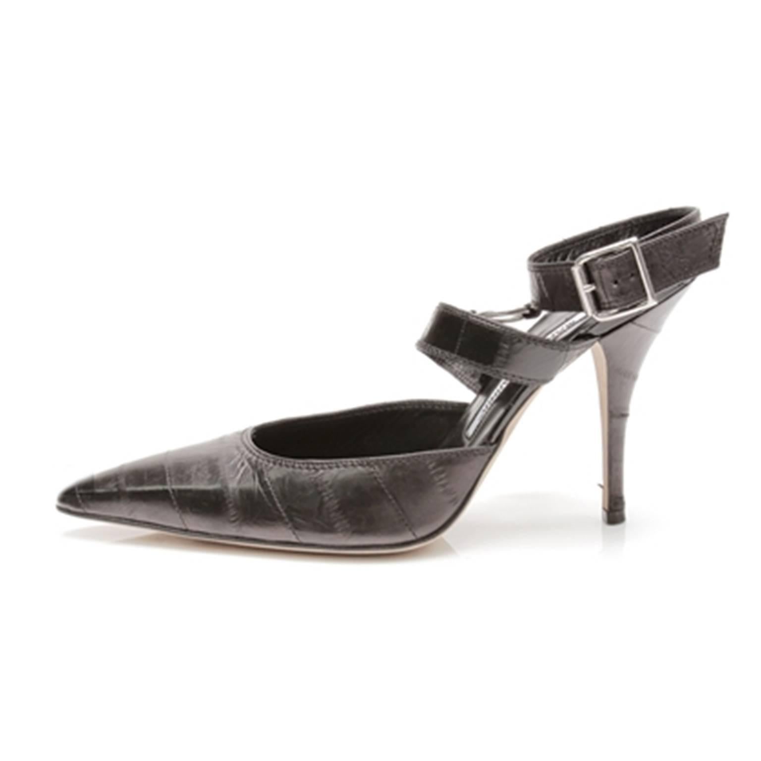 These Manolo Blahnik black eel skin heels are the finishing touches to any classic look. A timeless pointed toe is given a modern update with carefully considered straps and stunning silver-tone rings. Daytime meeting and evening affair approved,