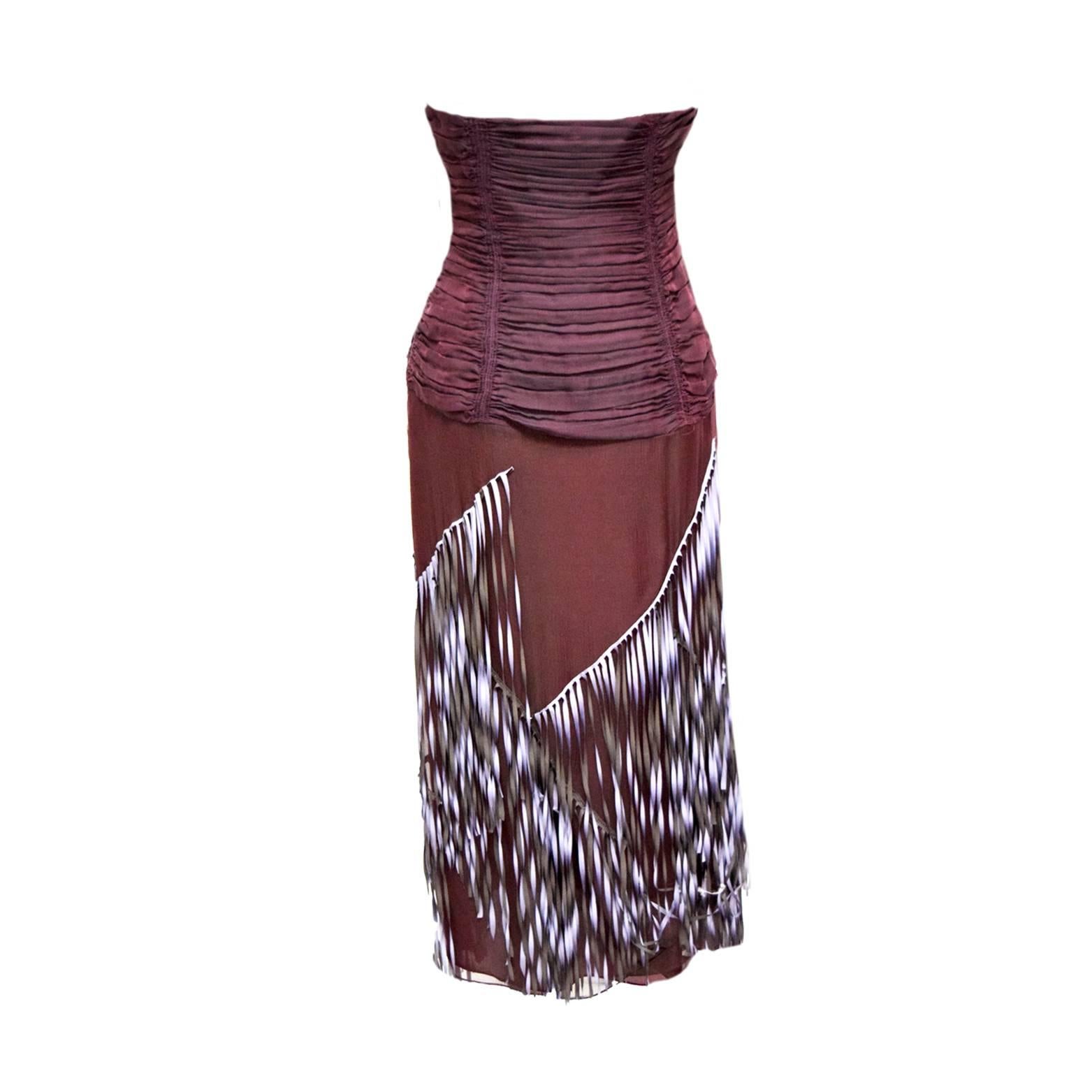 This unique and beautiful Lela Rose dress has periwinkle and olive fringe detailing along the skirting. The bodice is ruche merlot 100% Silk and gives the illusion of wearing an extravagant two piece. 