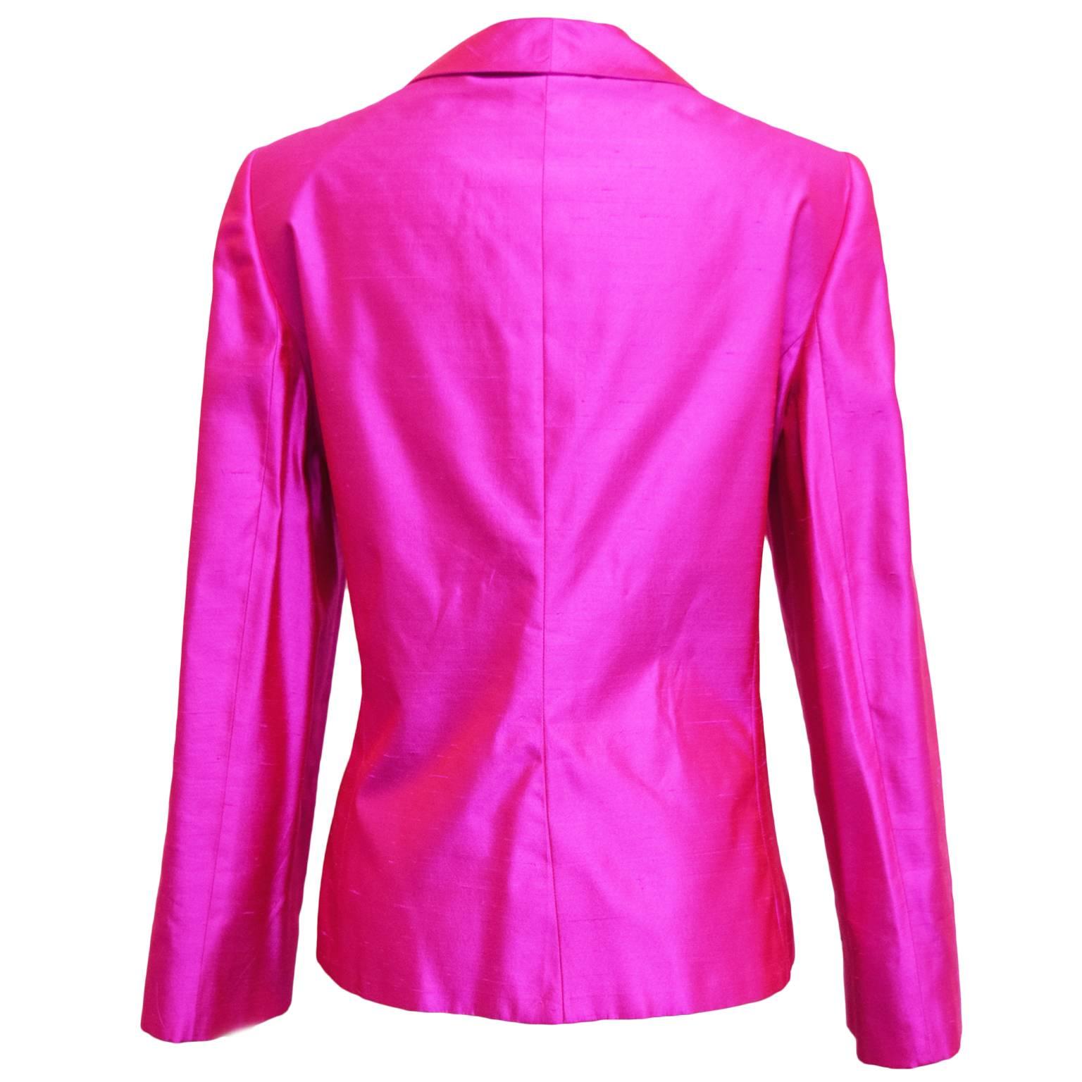 This retro Armani blazer is made from shantung iridescent fuchsia silk, and is single breasted. The gathering around the waist creates structure and shape, has side pockets and is fully lined.