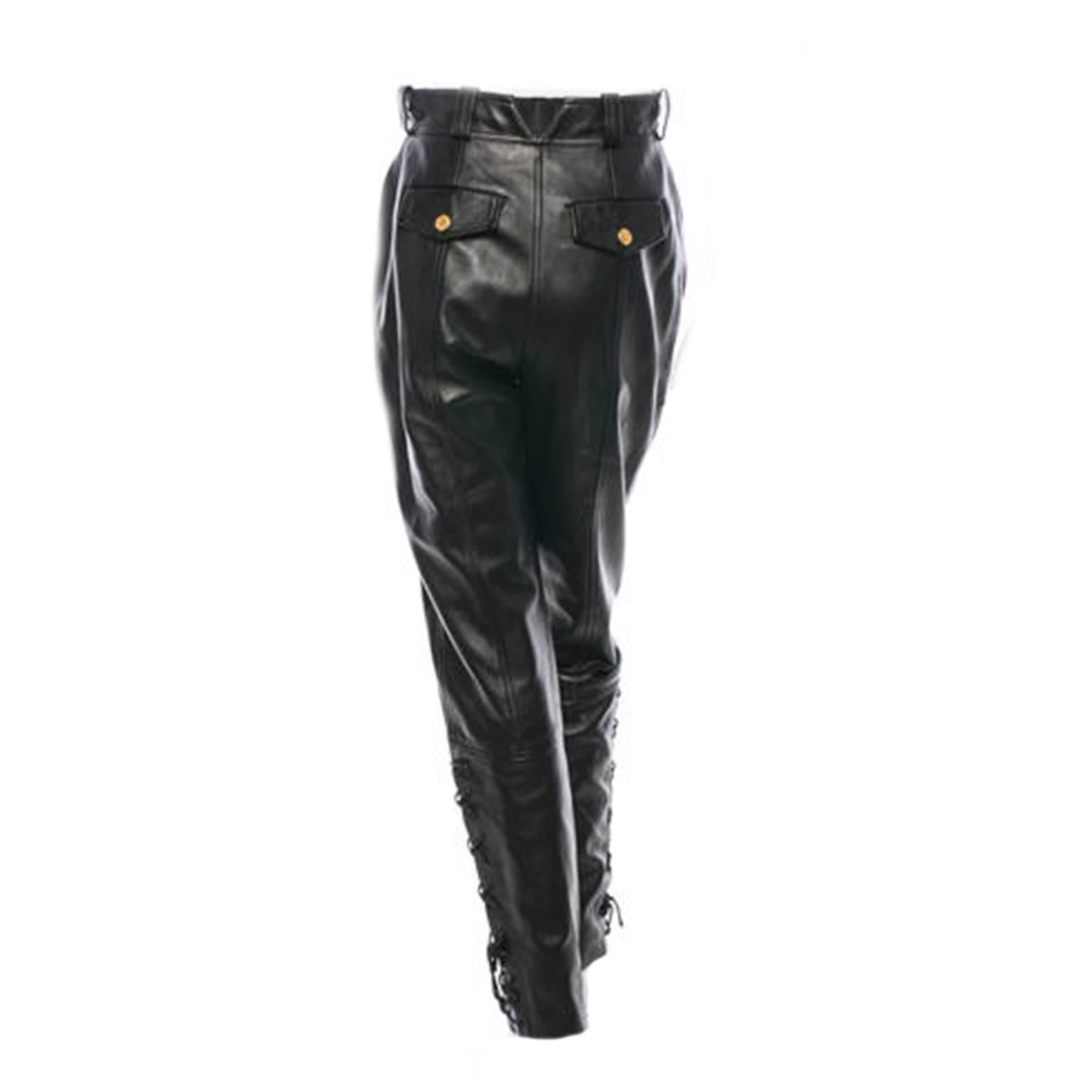 Black leather Chanel pants with four pockets, lace-up tie closures at sides, tonal stitching throughout and front zip closure.